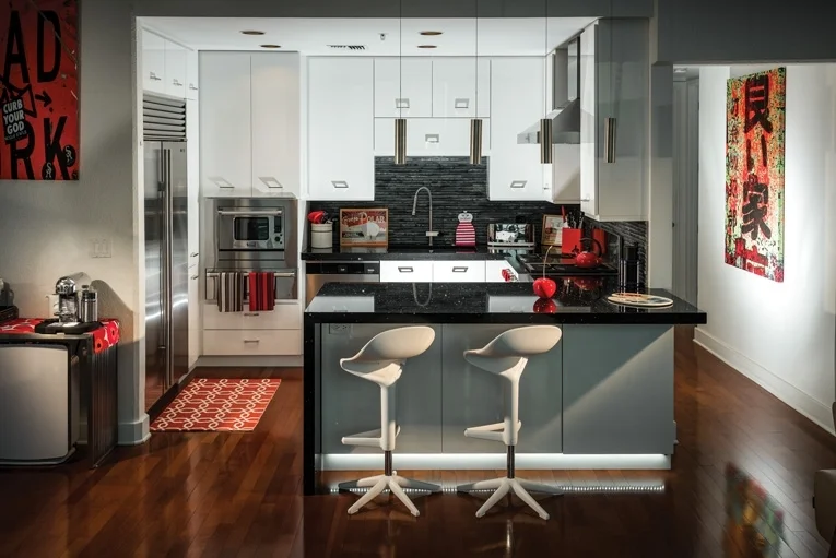 "Joshua Allen of Orlando’s AA Tile & Stone installed new black granite countertops and created a “waterfall” look by extending the granite vertically at the end of the counter. The effect contributed to the kitchen’s overall contemporary Poggenpohl look." -Orlando Magazine, October 2016