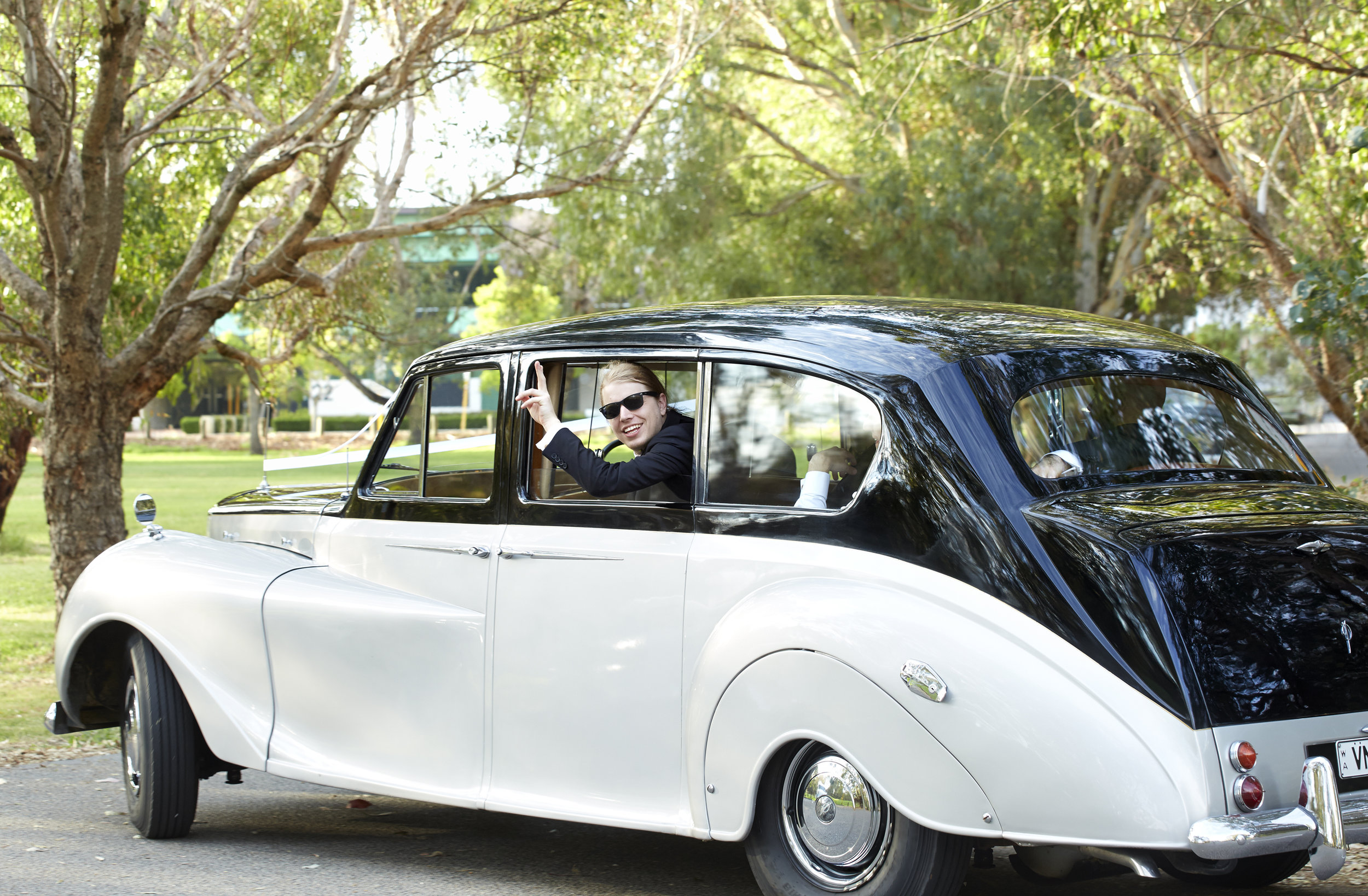 25-groomsman-waving-from-wedding-car-window-in-perth-very-nice-classics.jpeg