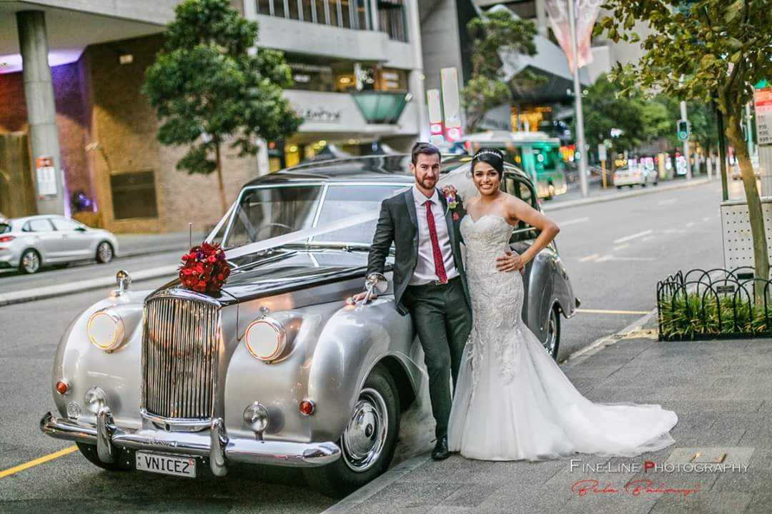 FineLine-Photography-Nicole-and-Peter-with-Very-Nice-Classics-wedding-car-with-flower.jpg