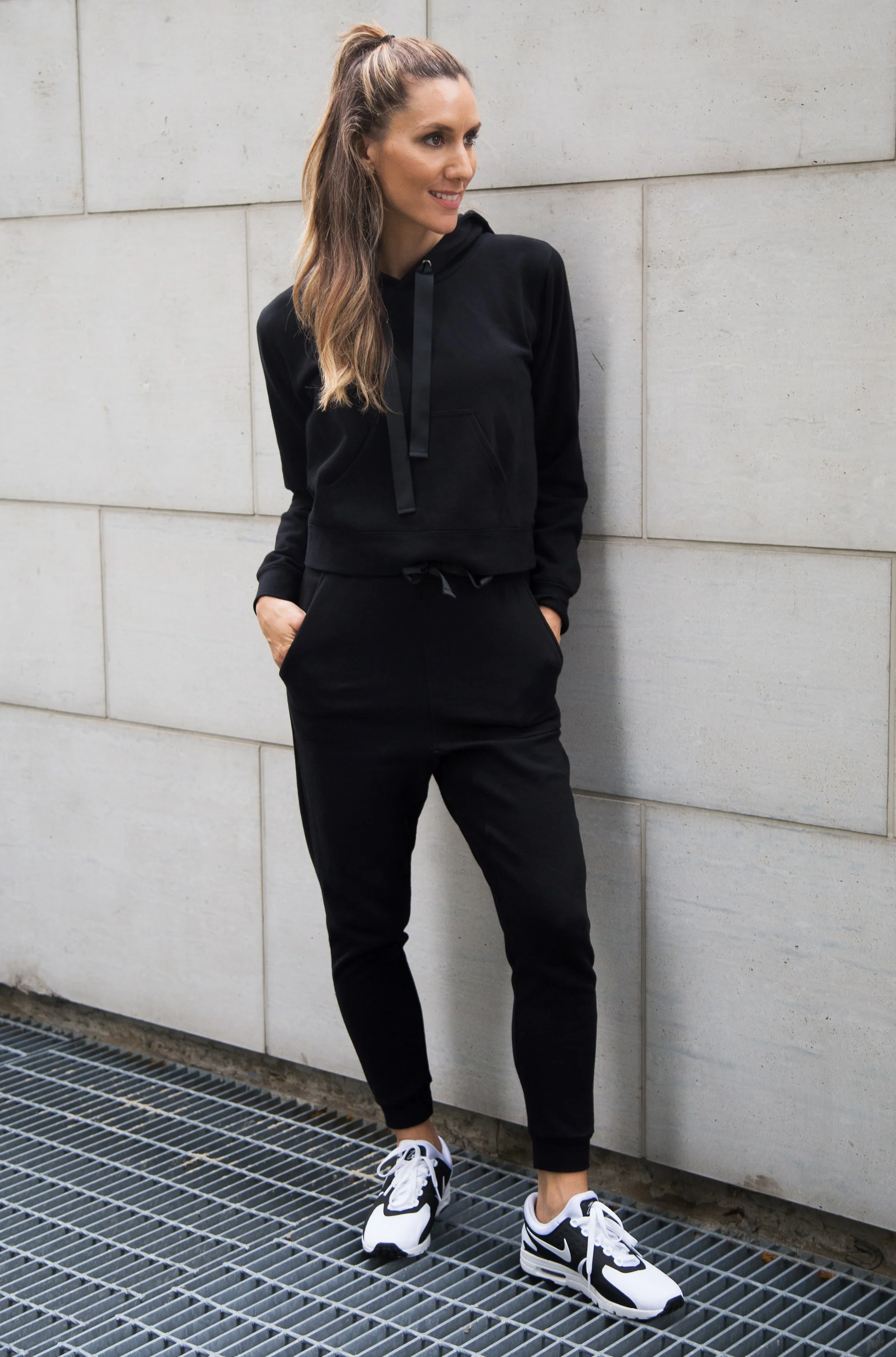 Black athleisure outfit with snakeskin boots
