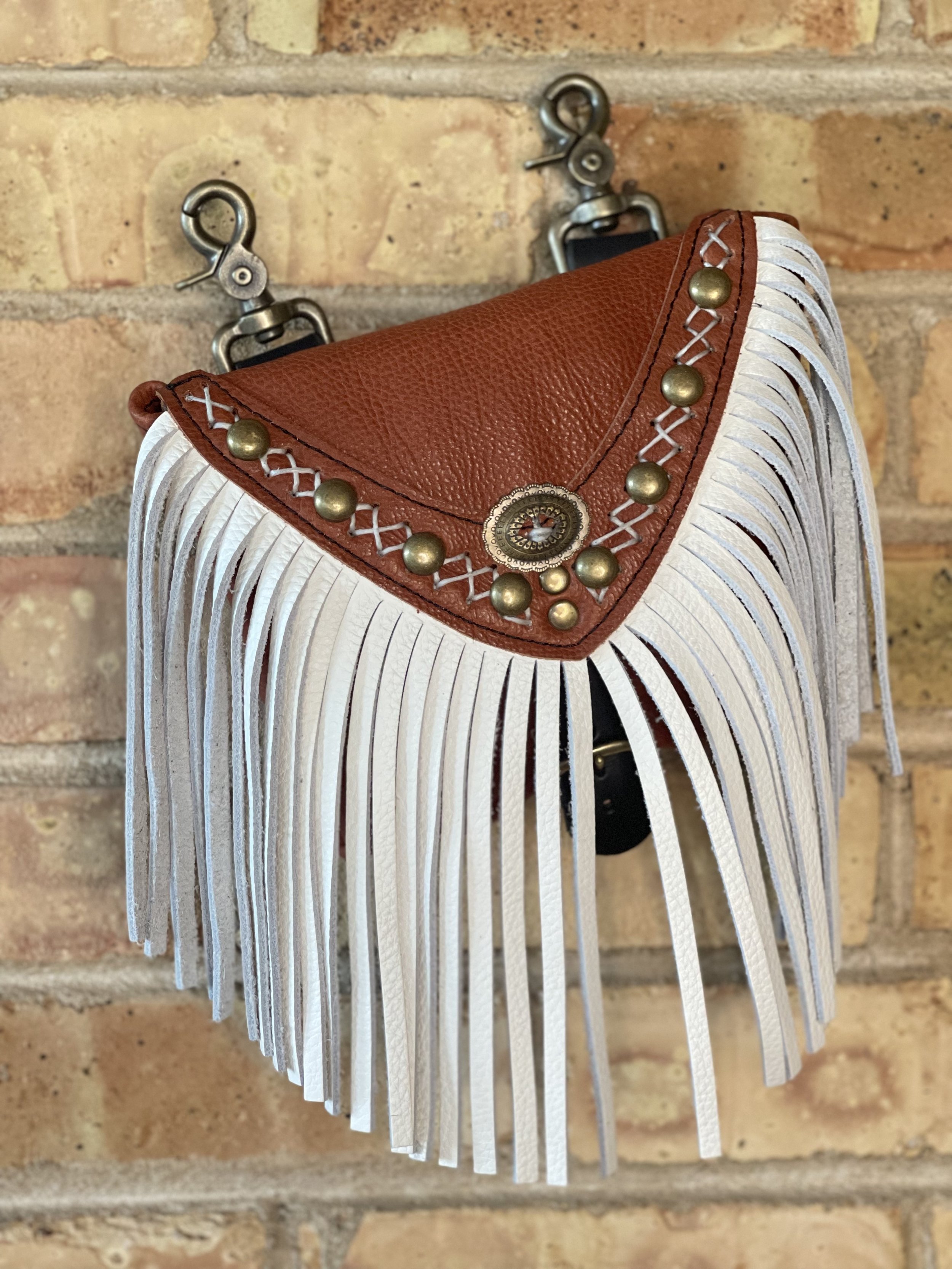 On The Road Hip Bag in Tobacco Bison, White Fringe, White Criss Cross Handstitching, Studs, and a Concho