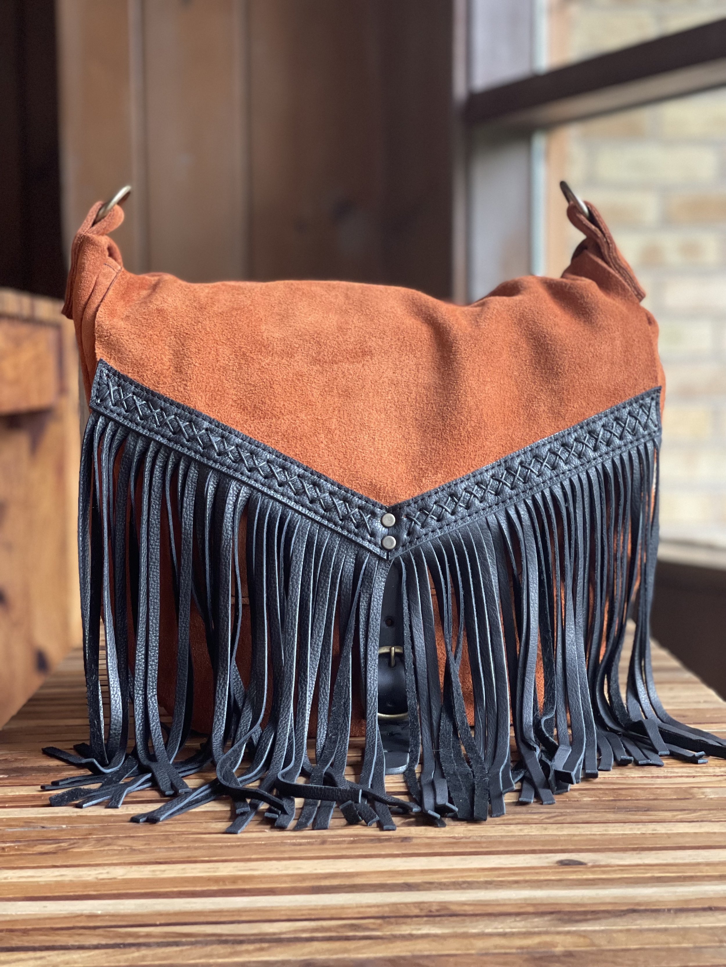  Body: Rust Suede Fringe: Black Bison Leather Fringe Border: Black Bison Leather Custom Gusset Placement D Ring Tabs: Rust Suede Antique Brass Hardware Black Criss Cross Hand-Stitching 