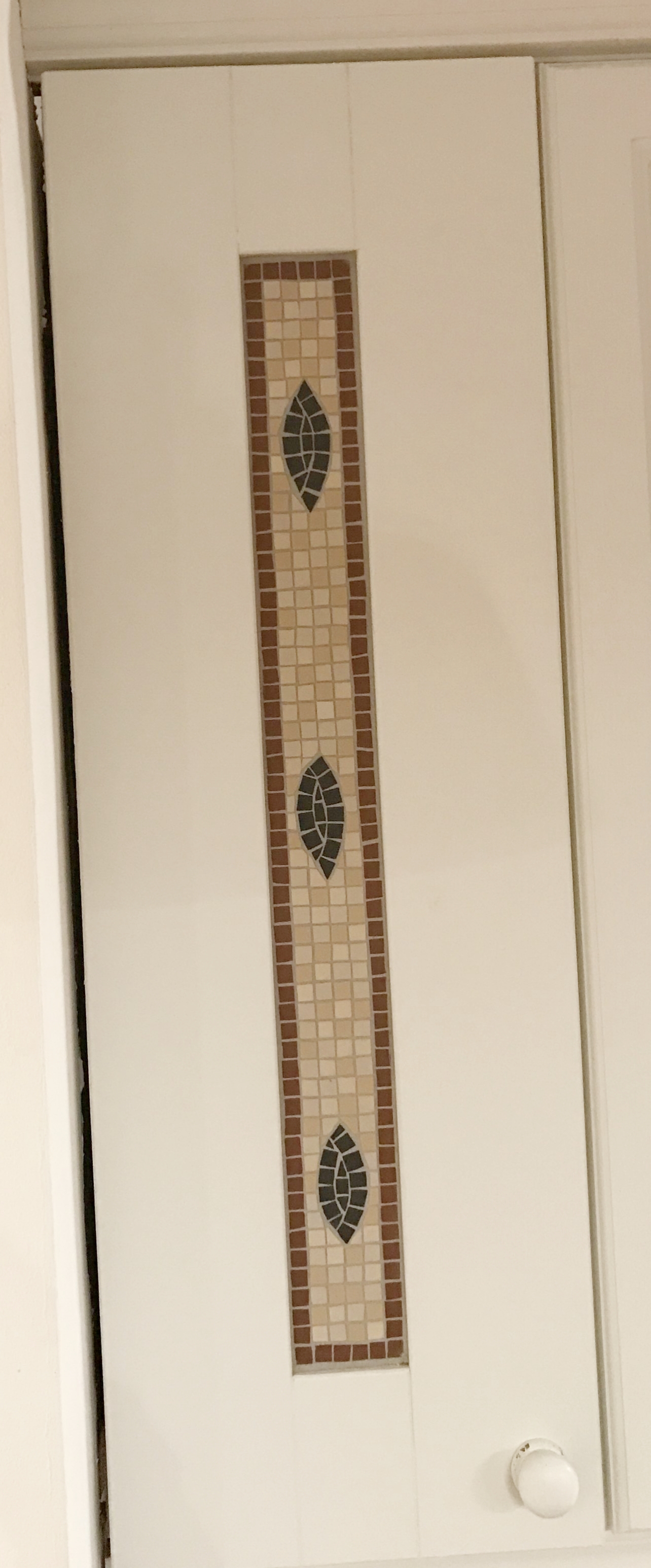 Kitchen cupboard door mosaic inset.