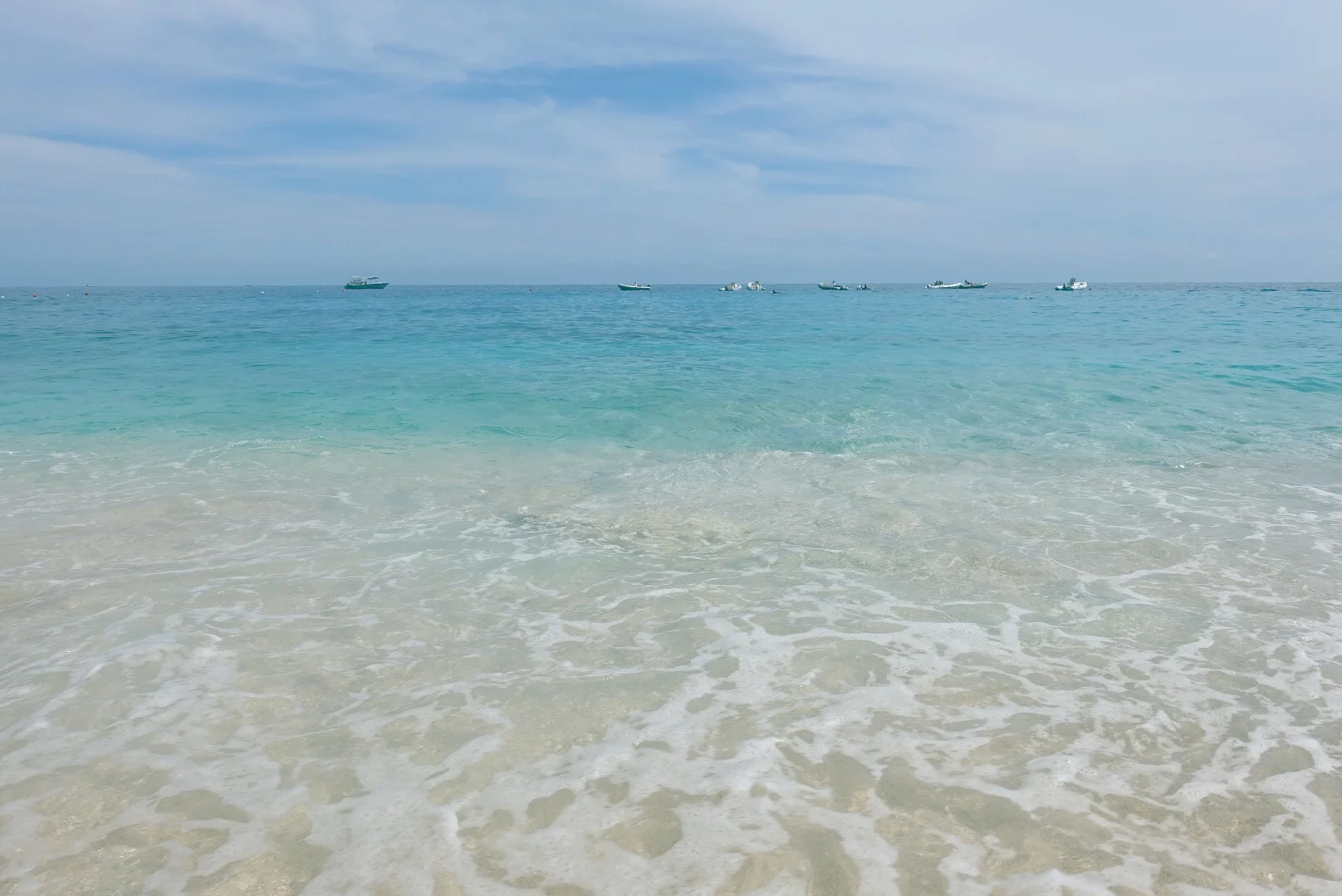 Our boat is somewhere out there. You're not allowed to dock the boat on the beach, so you have to unpack on the beach, and then anchor your boat about 200m from the shore and some poor sucker (in this case, Adam) has to swim in.