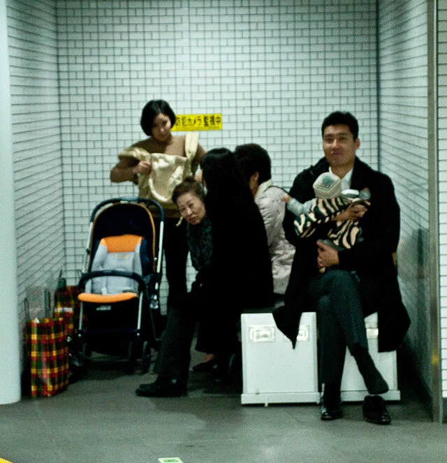 Stranded family waiting inside the warm station. It was a particularly cold night in Tokyo.