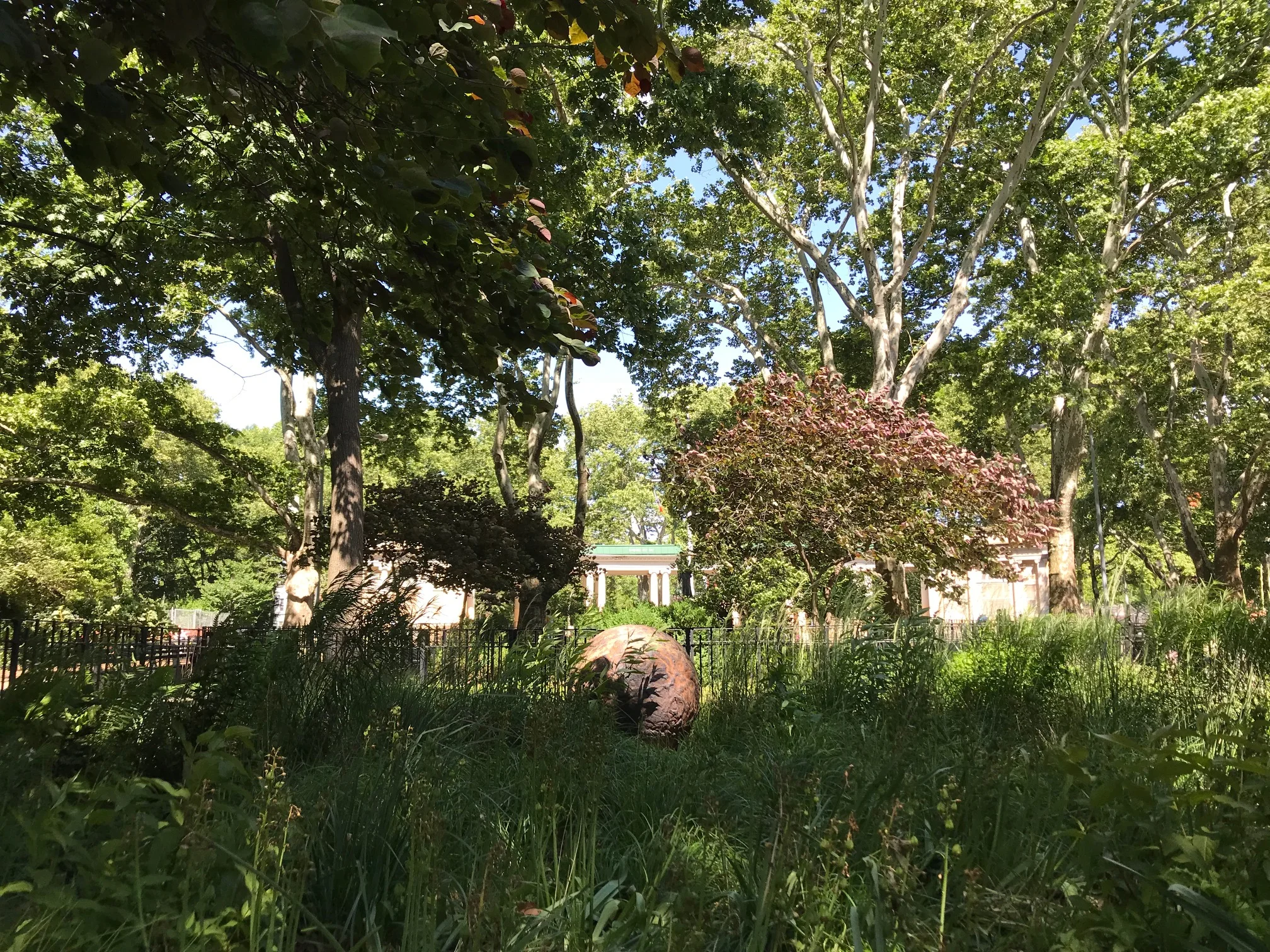 The ceramic orb in the meadow in McGolrick Park.