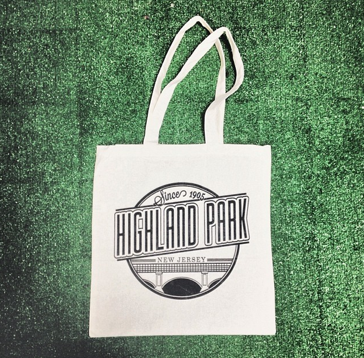 HIGHLAND PARK TOTE BAG We created the Highland Park logo to pay homage to Highland Park, NJ's roots as a turn of the century town built on the heels of industry. Its classic design has proven to be a favorite to Highland Park residents, and is always being printed on your new favorite tee/hoodie. We offer the same bags in a variety of colors for custom print jobs!