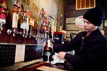 Brewer Todd Henry filling a growler of AJ Porter