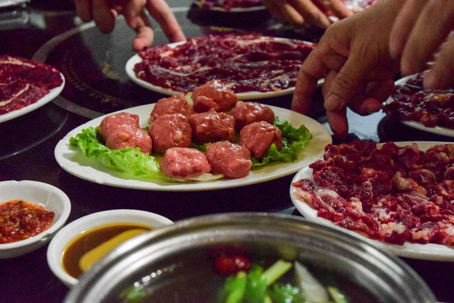 Raw beef, including Teoswa's famous beef meatballs, at a beef hotpot restaurant. Teoswa-style hotpot requires fresh (not aged) beef
