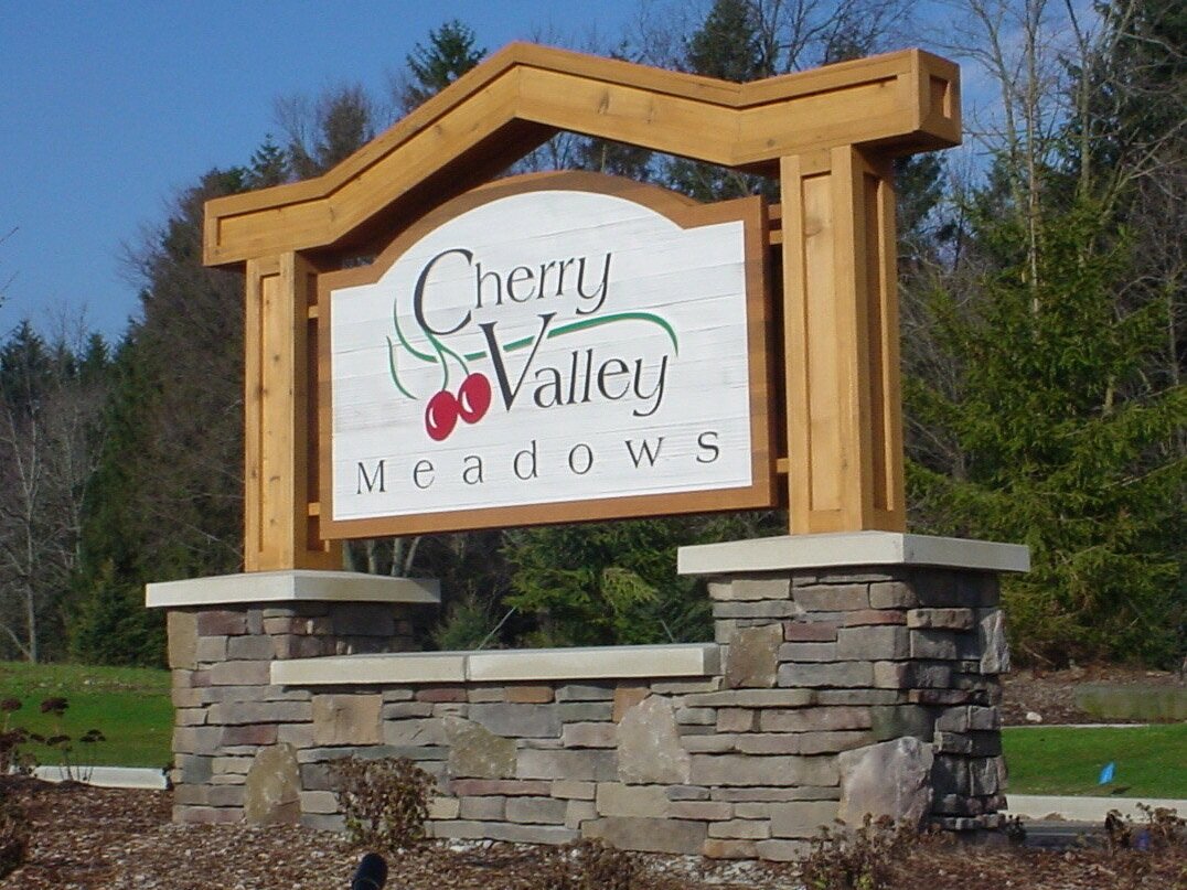  Monument sign with Cedar sign panel, Cedar columns and header and stone masonry base. 