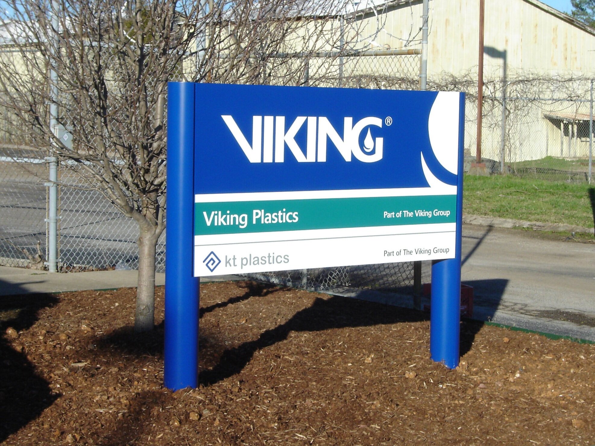  Monument sign with aluminum sign panel and round aluminum posts with vinyl graphics. 