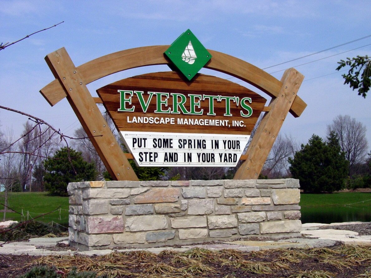  Monument sign with sandblasted Cedar panel, custom Cedar columns and header beam with stone masonry base. 