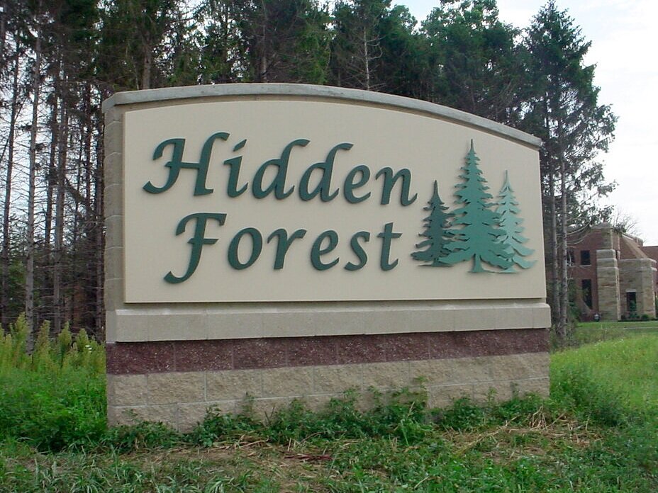  Monument with a masonry wall and an aluminum sign panel with dimensional lettering. 