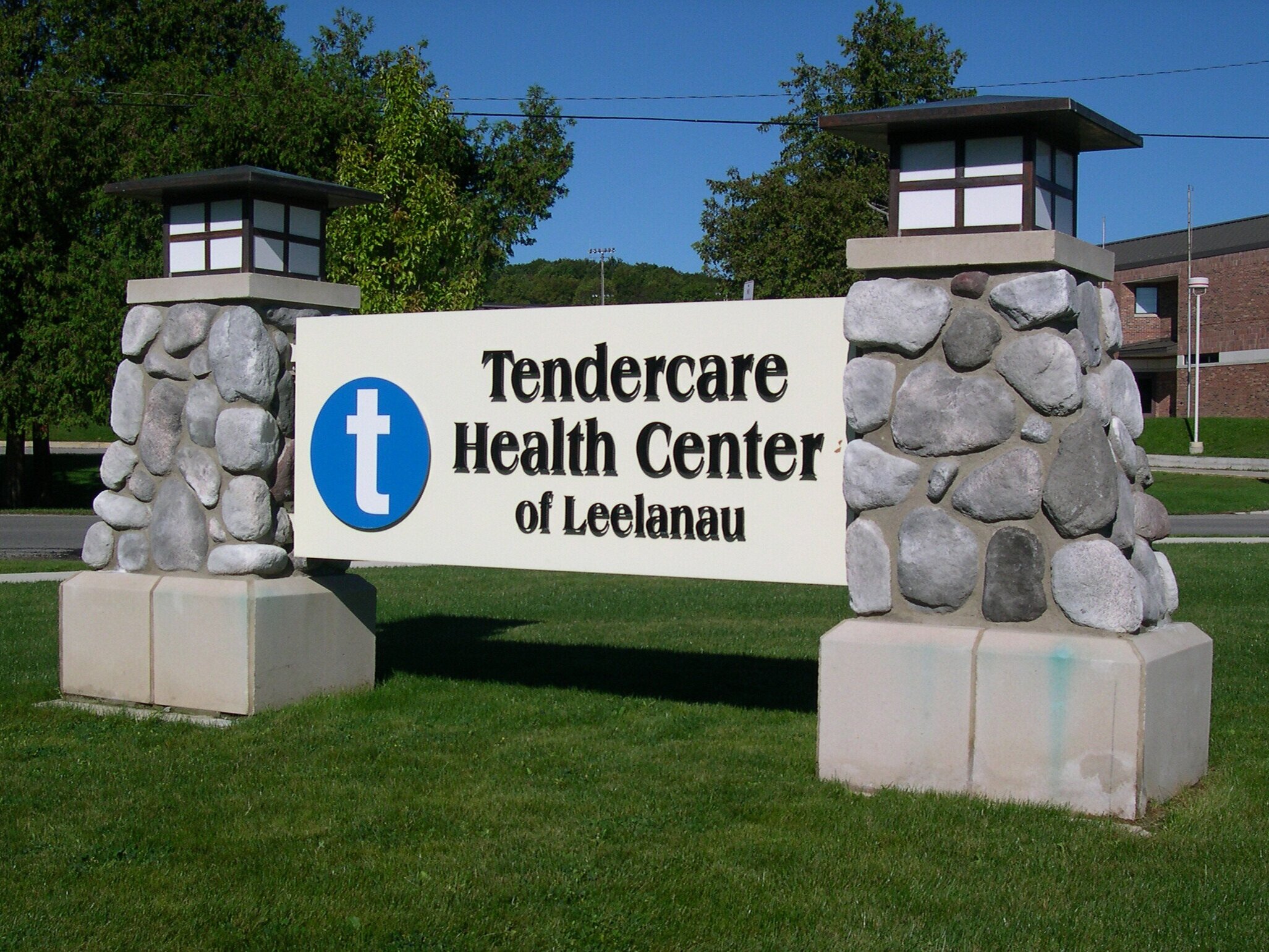  Monument sign with aluminum structure, dimensional lettering and stone columns. 