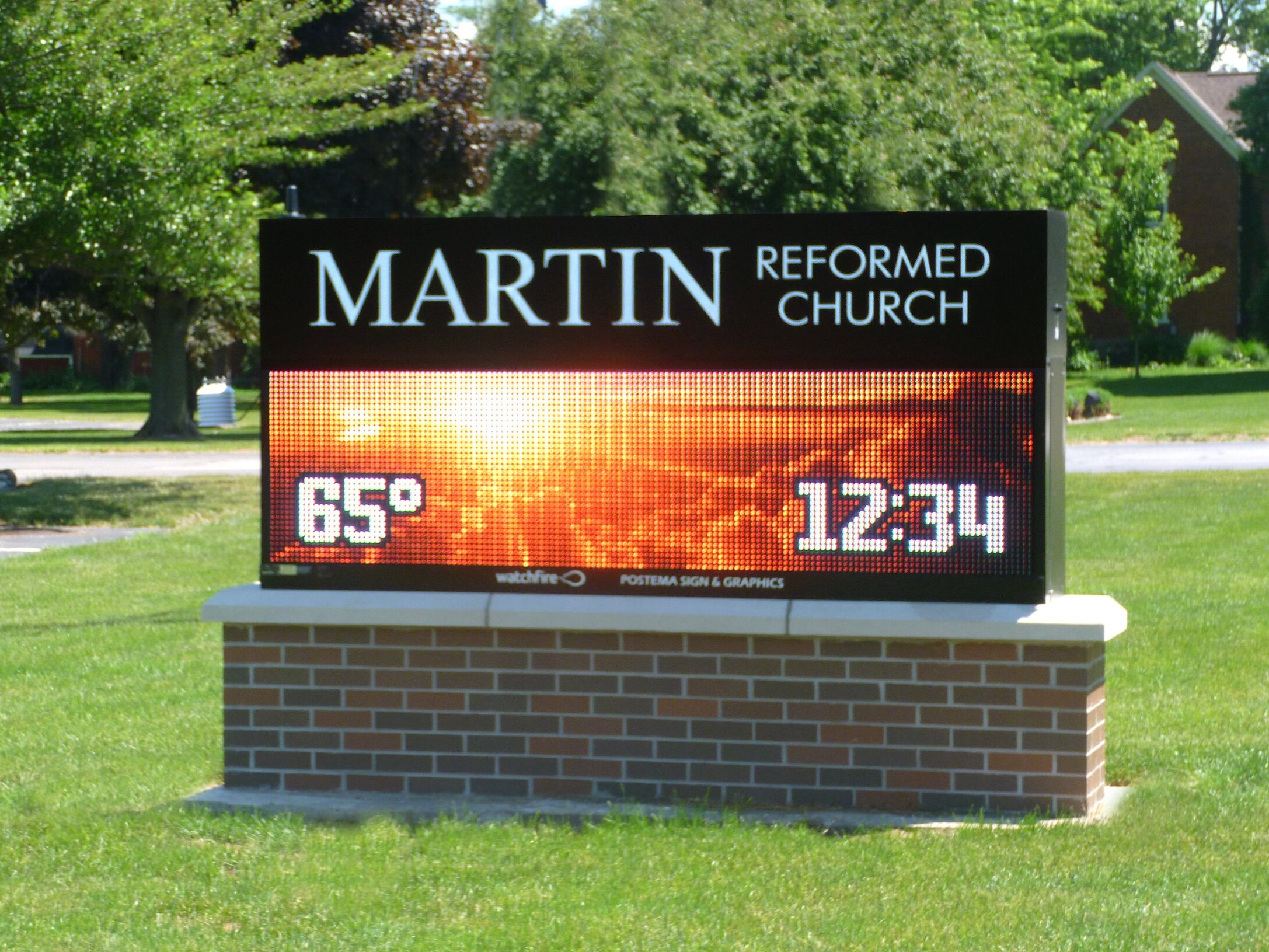  Monument sign with a custom aluminum cabinet with routed aluminum faces, push through acrylic lettering, masonry base and a Watchfire 16mm display. 