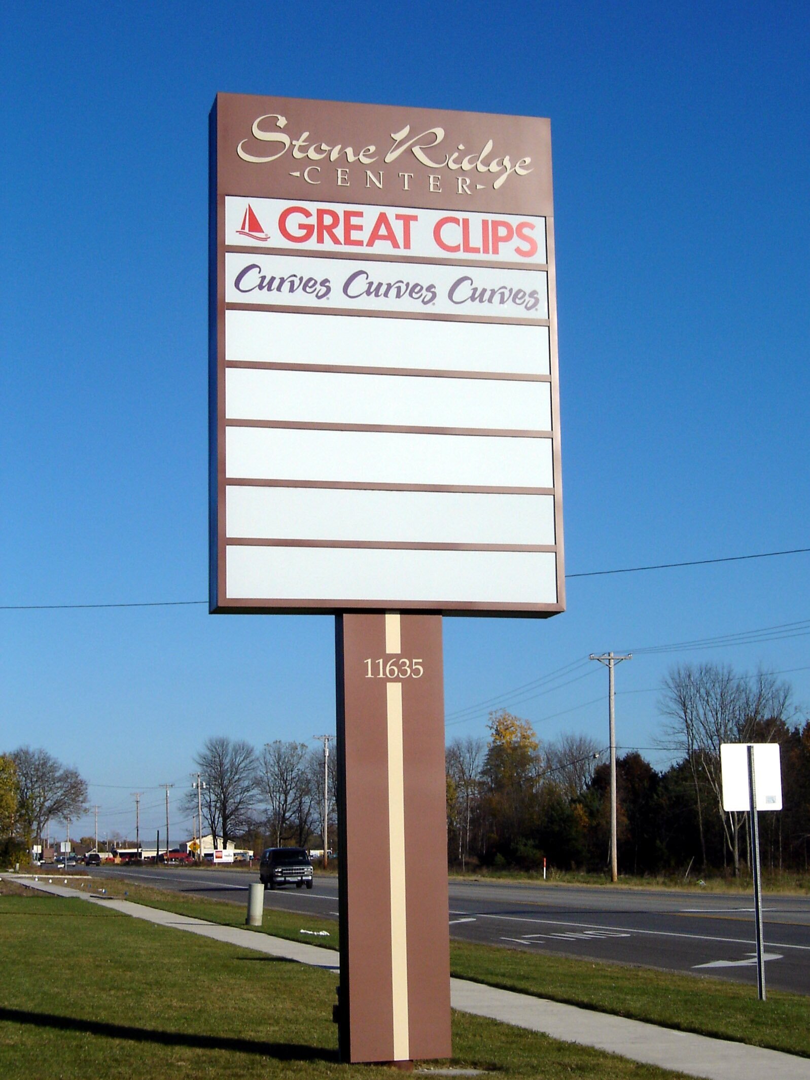  Multi-tenant pylon sign with routed aluminum header panel and polycarbonate tenant panels with an aluminum pole cover. 