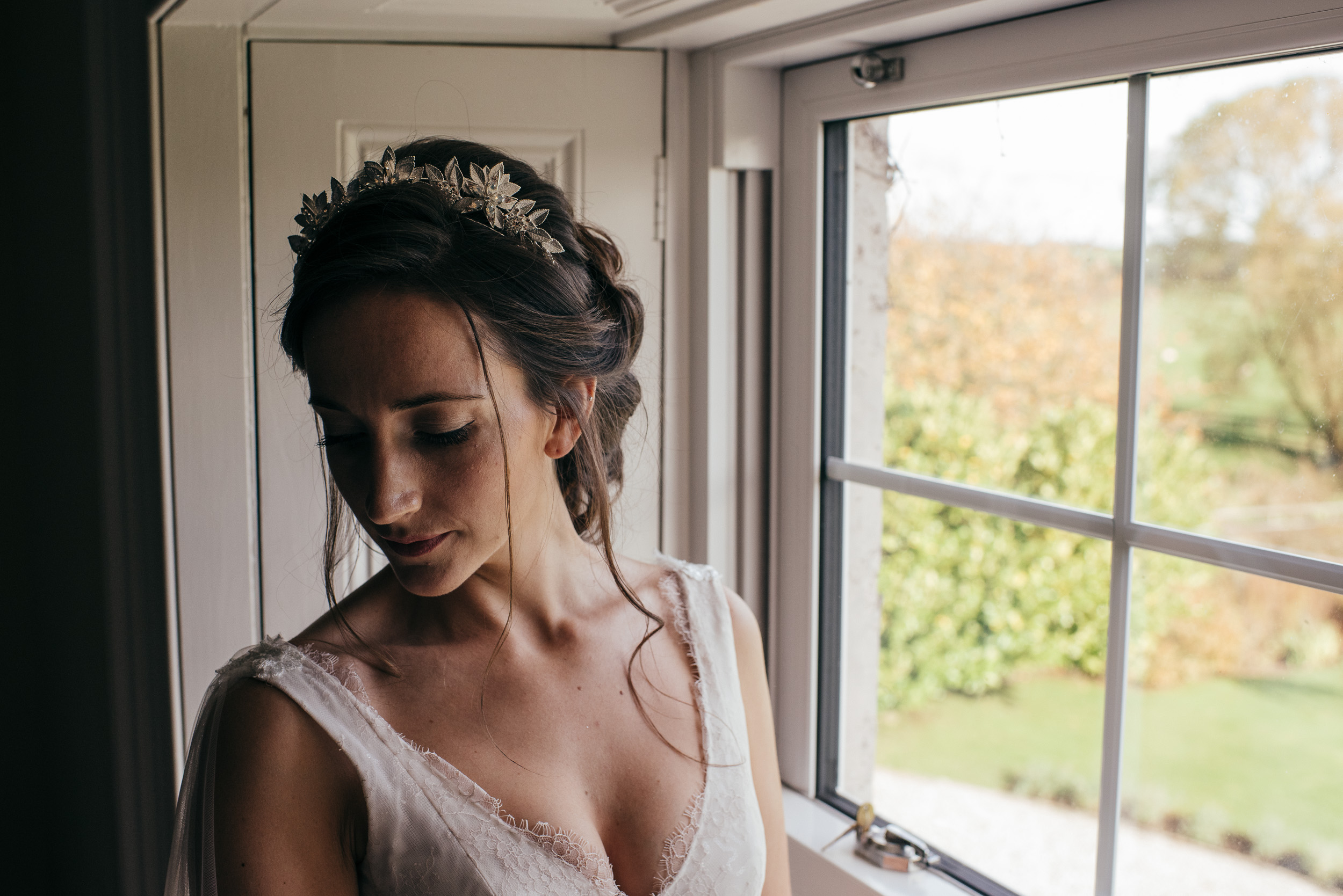 Bride showered by window light