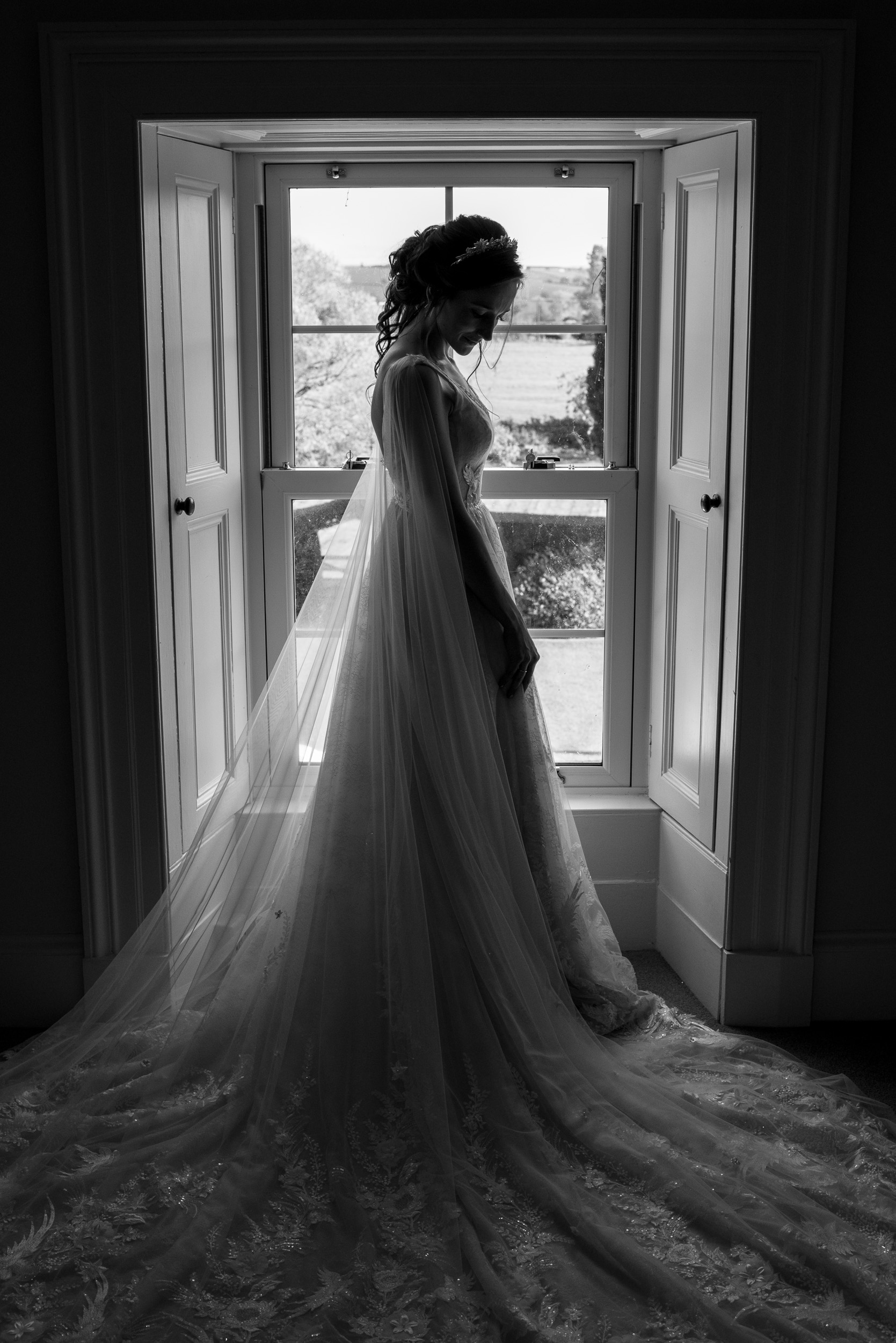 Bride showered by window light