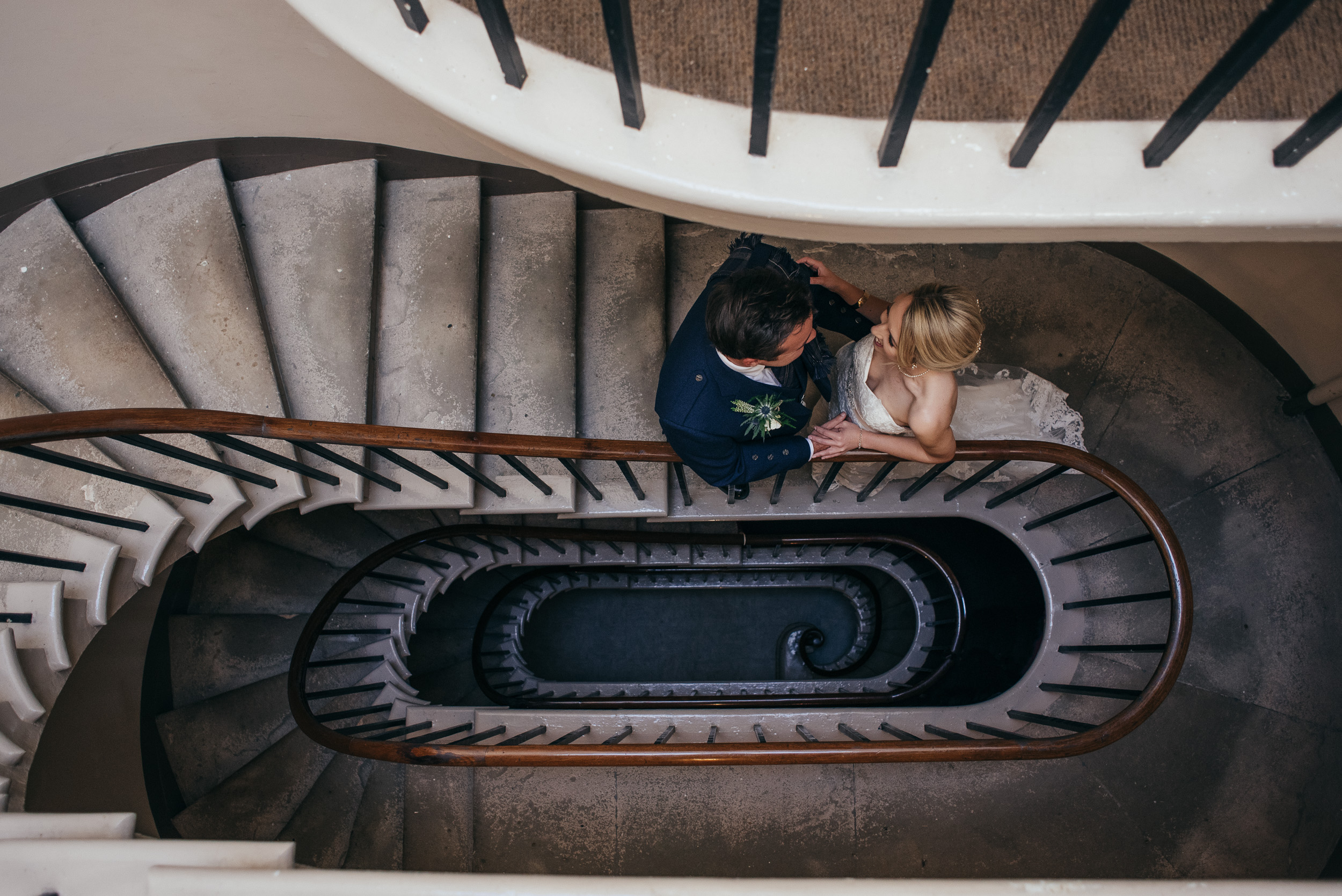 Bride and groom on spiral stairs