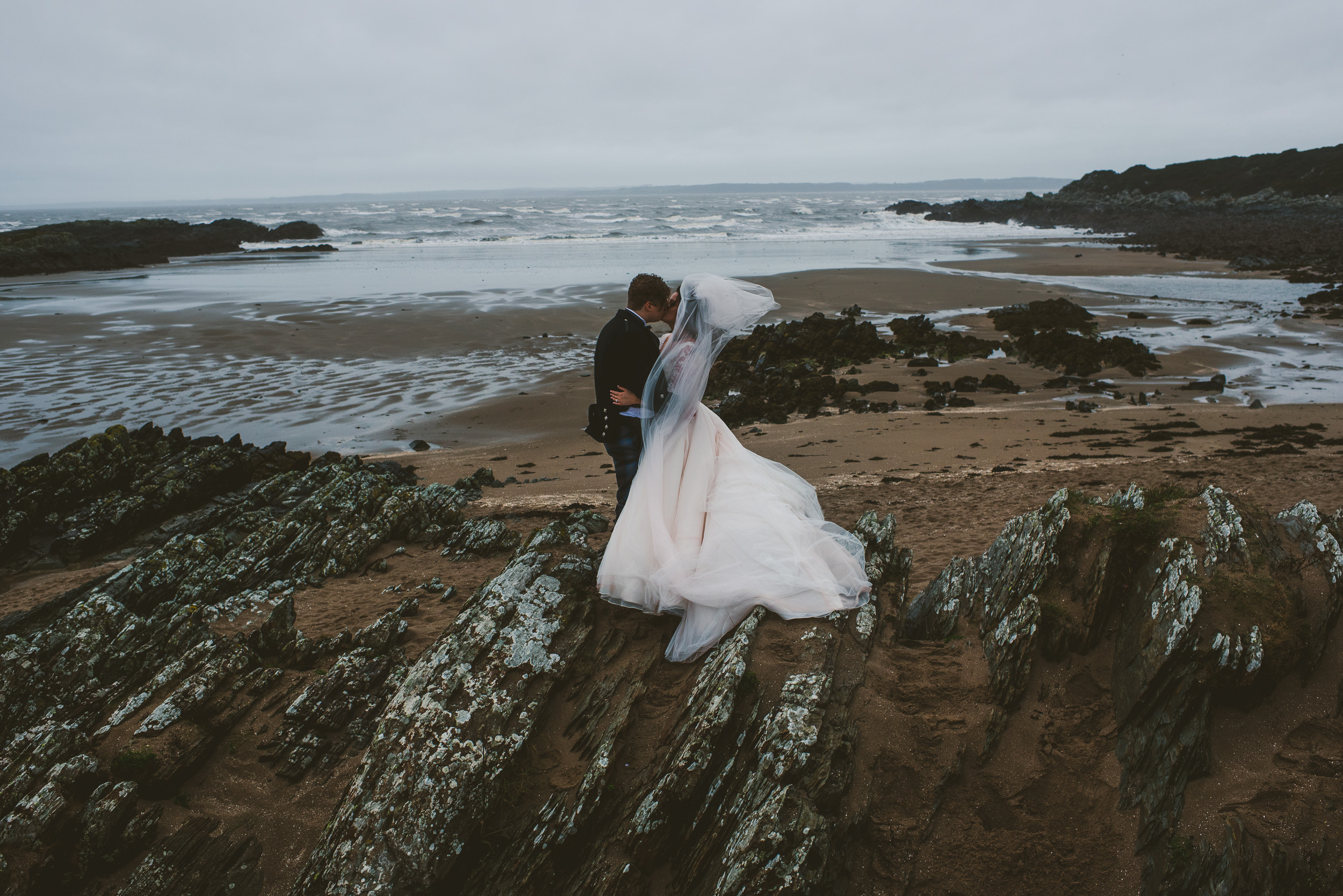 Wedding portrait on windy beach