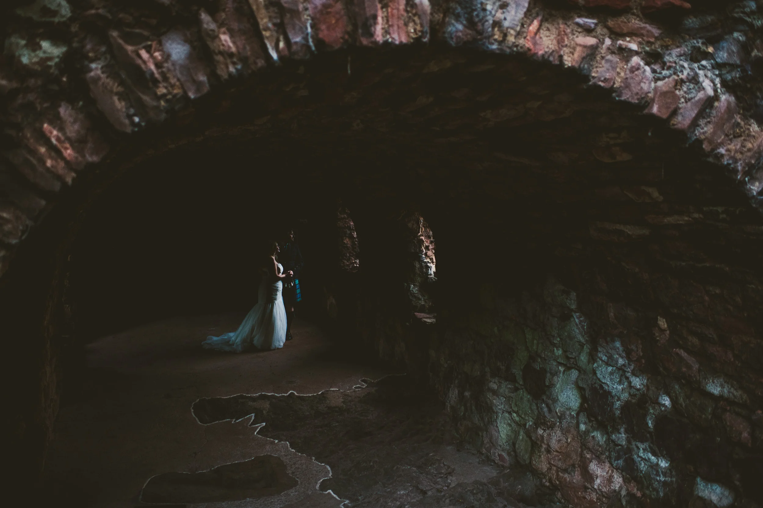 Bride and groom finding light in castle