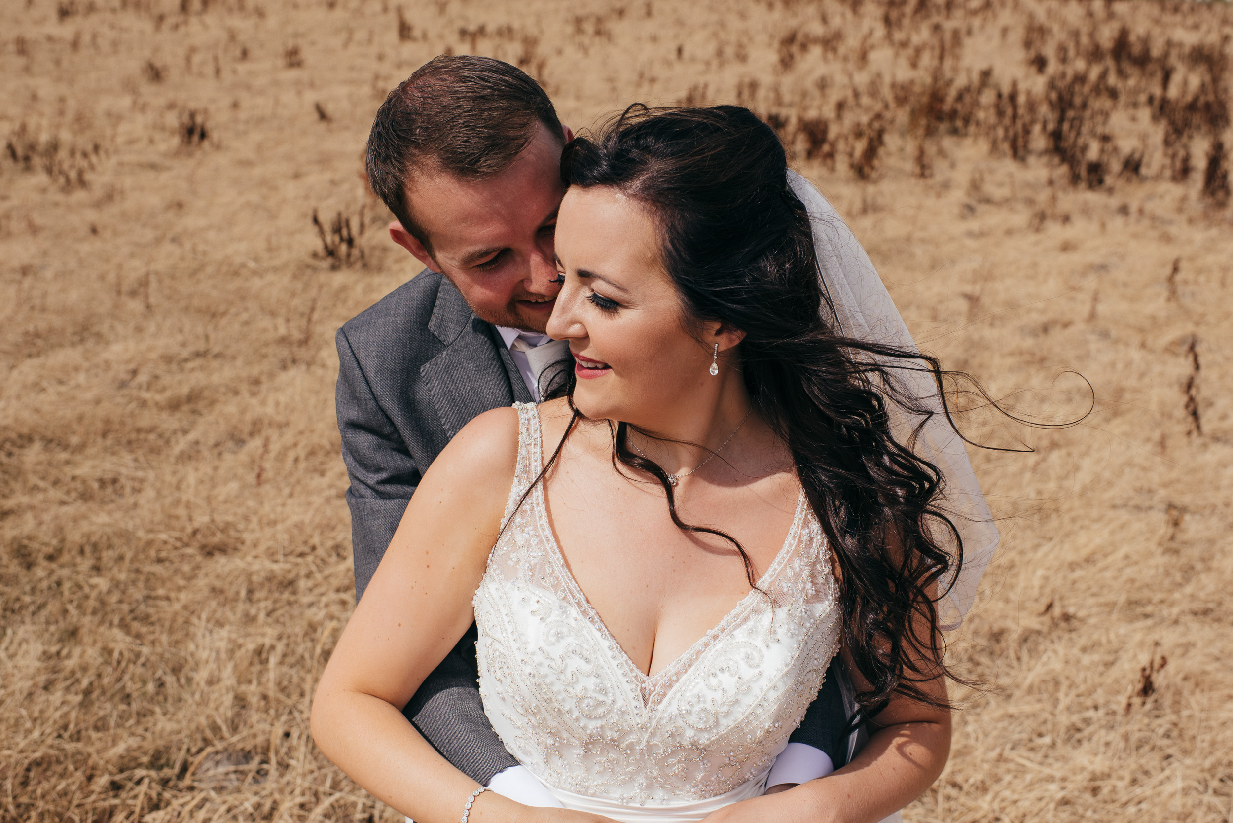 Bride and groom in field