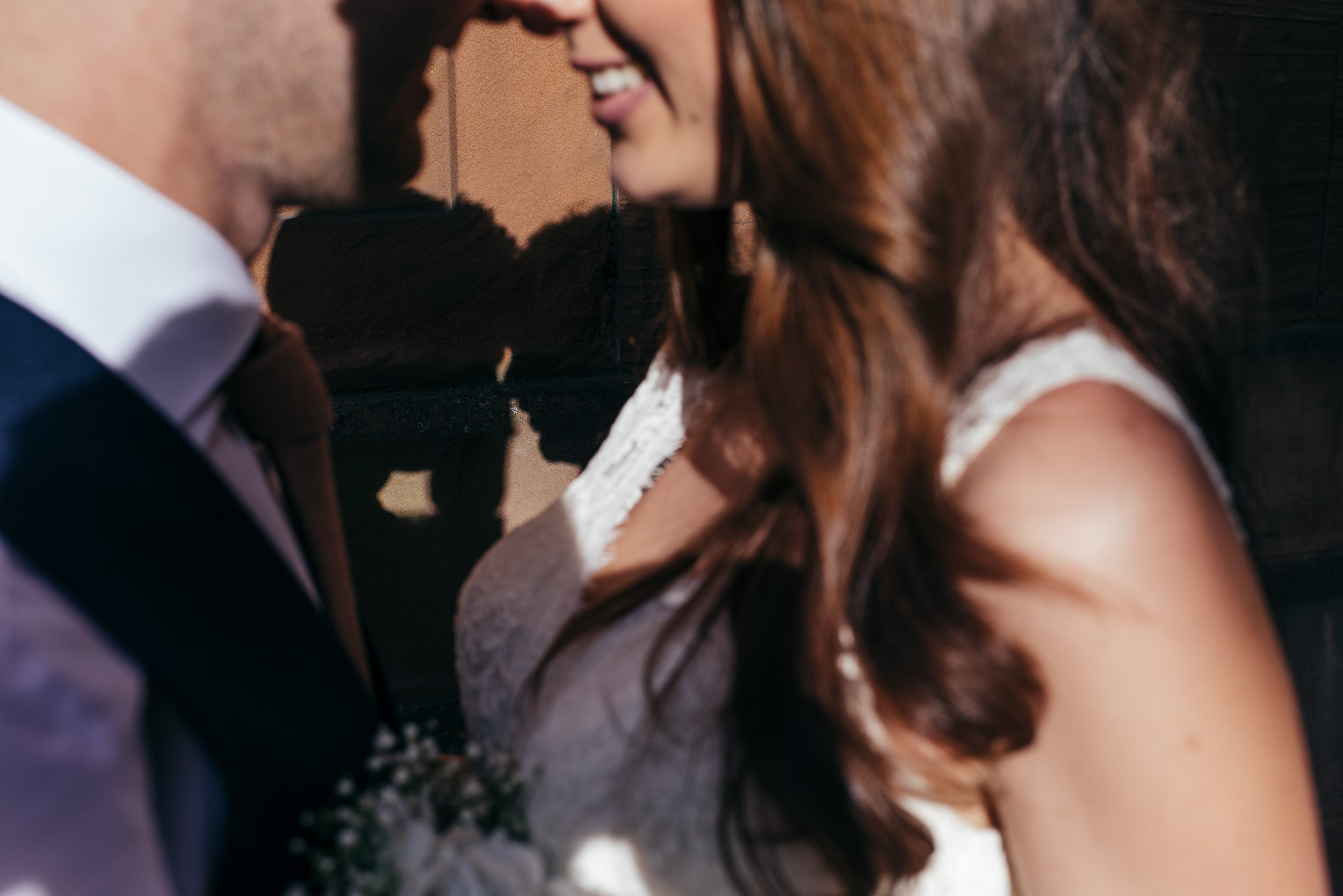 Bride and grooms faces in shadow