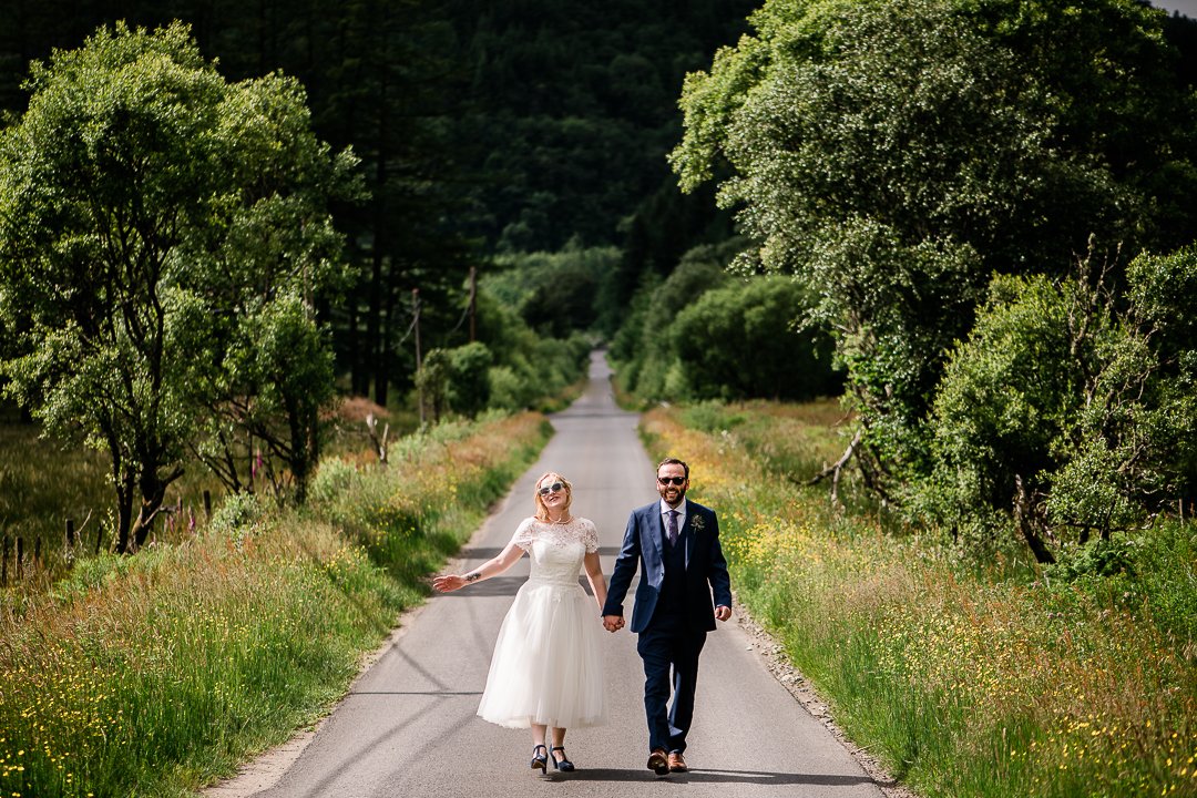 Bride and groom on open road