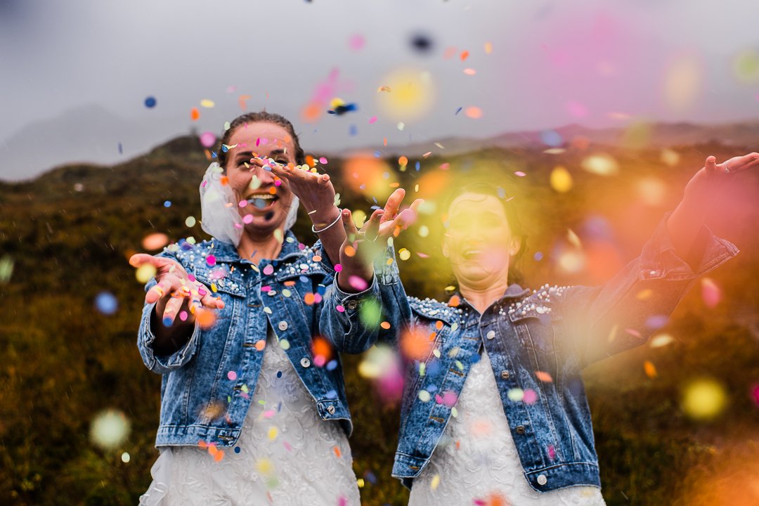 Confetti in the wind with two brides