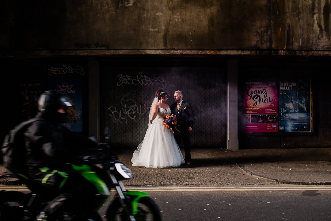 Bride and groom with motorbike