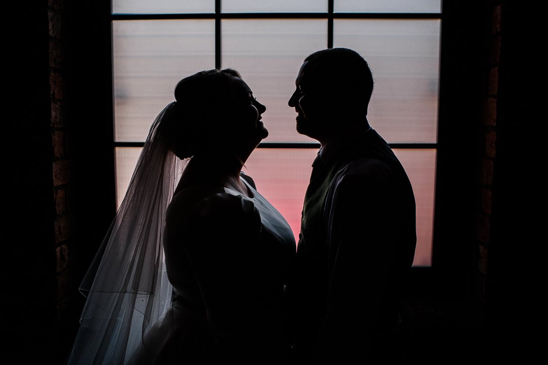 Bride and groom window silhouette