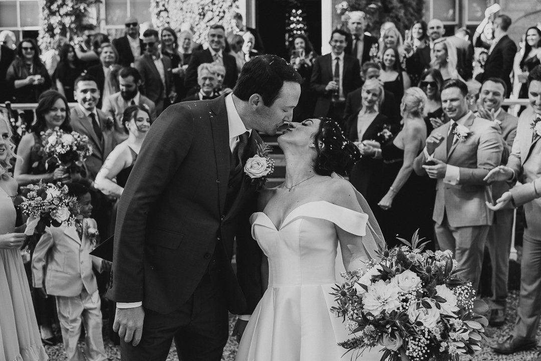 Black and white bride and groom kiss
