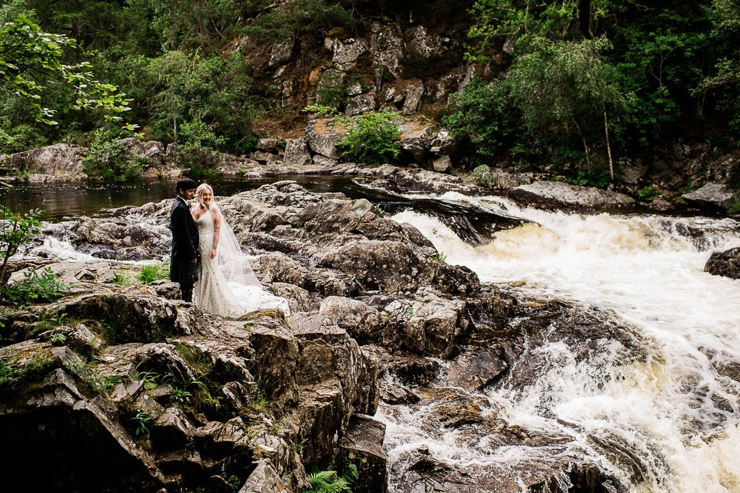 Bride and groom on waterfall