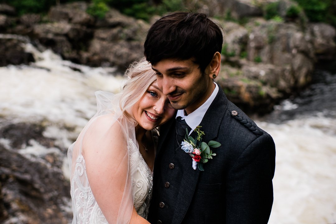 Bride and groom by a Scottish river