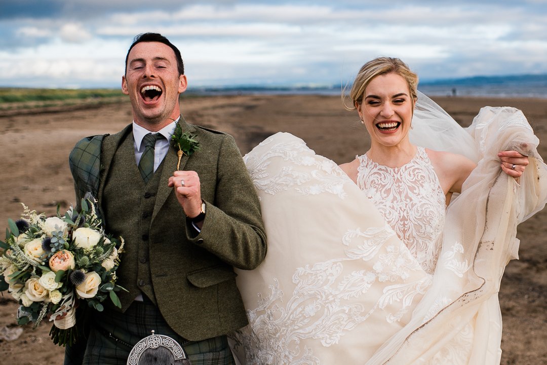 Happy running bride and groom
