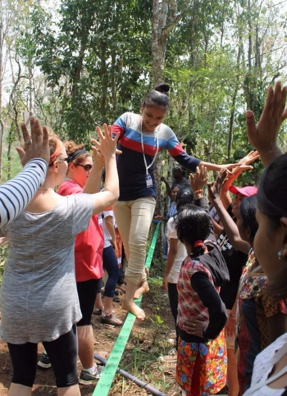 The Freedom 4/24 India team high-fives a teenage trafficking survivor as she completes an activity at Wilderness Camp in April. 
