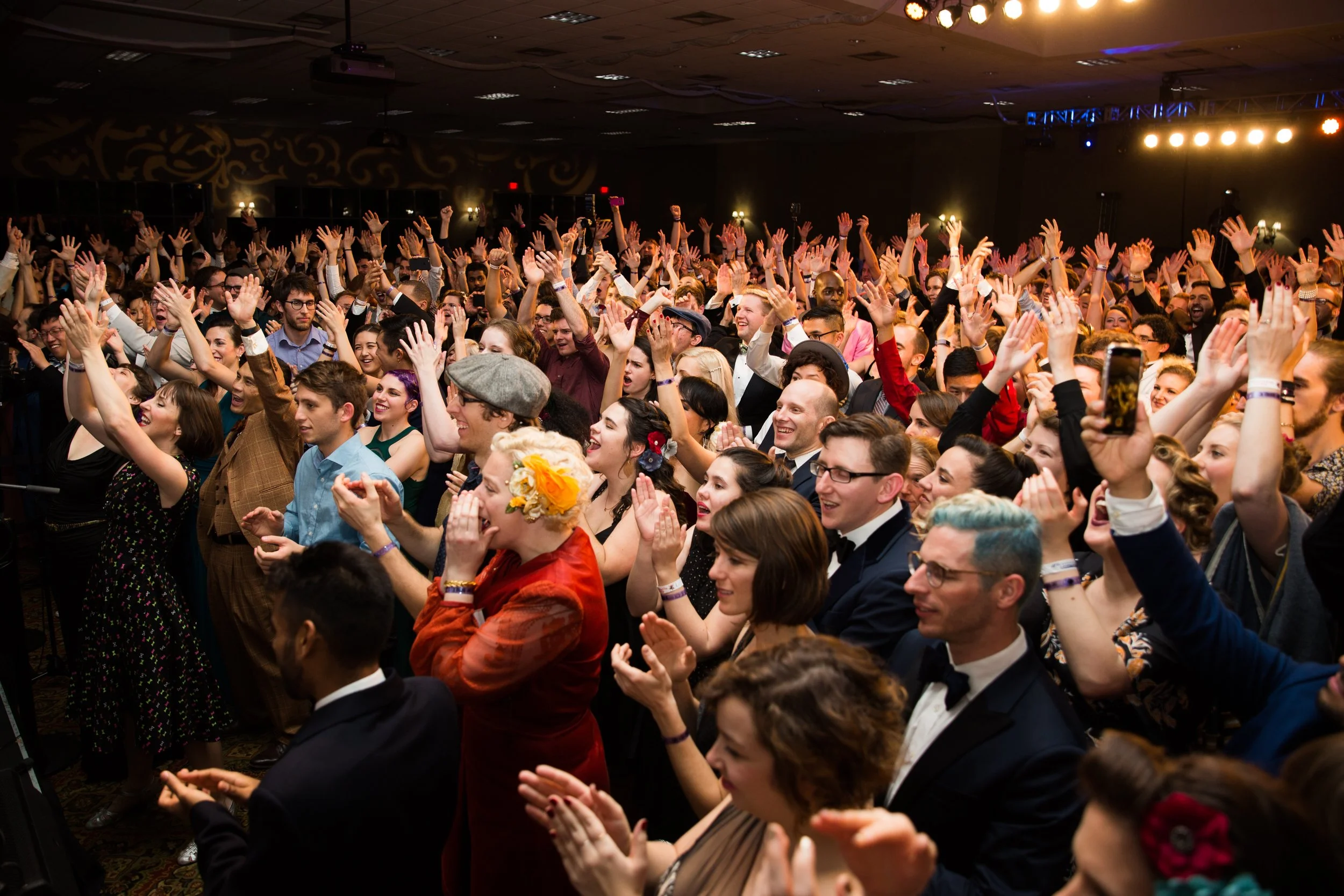 A huge group of dancers cheering for a band during a lively dance event in Lisbon, Portugal, captured by a professional event photographer. The energetic atmosphere, expressive movement, and vibrant social setting showcase the excitement of Lisbon’s 
