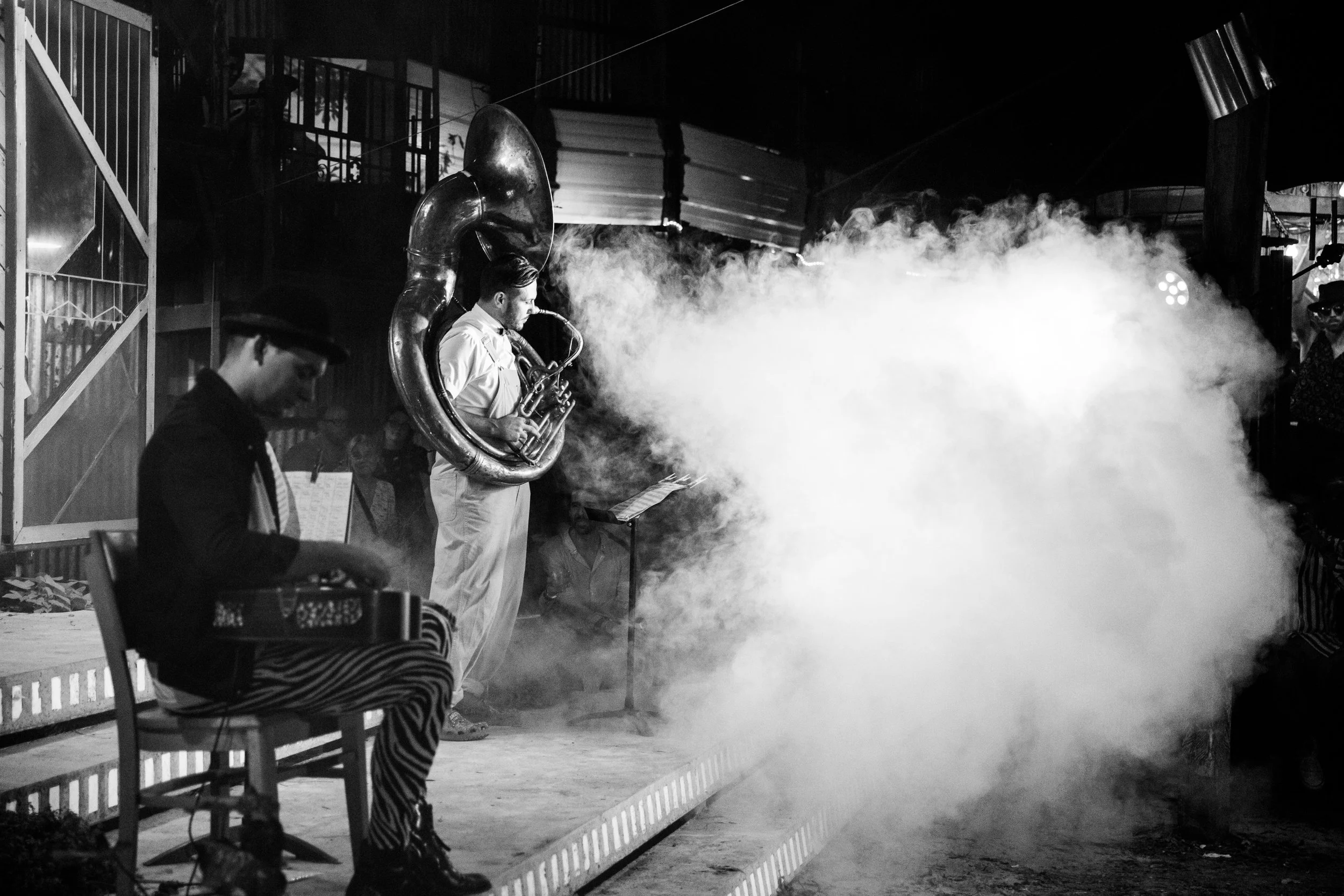 Musicians during a lively dance event in Lisbon, Portugal, in moody lighting with a fog machine, captured by a professional event photographer. The energetic atmosphere, expressive movement, and vibrant social setting showcase the excitement of Lisbo