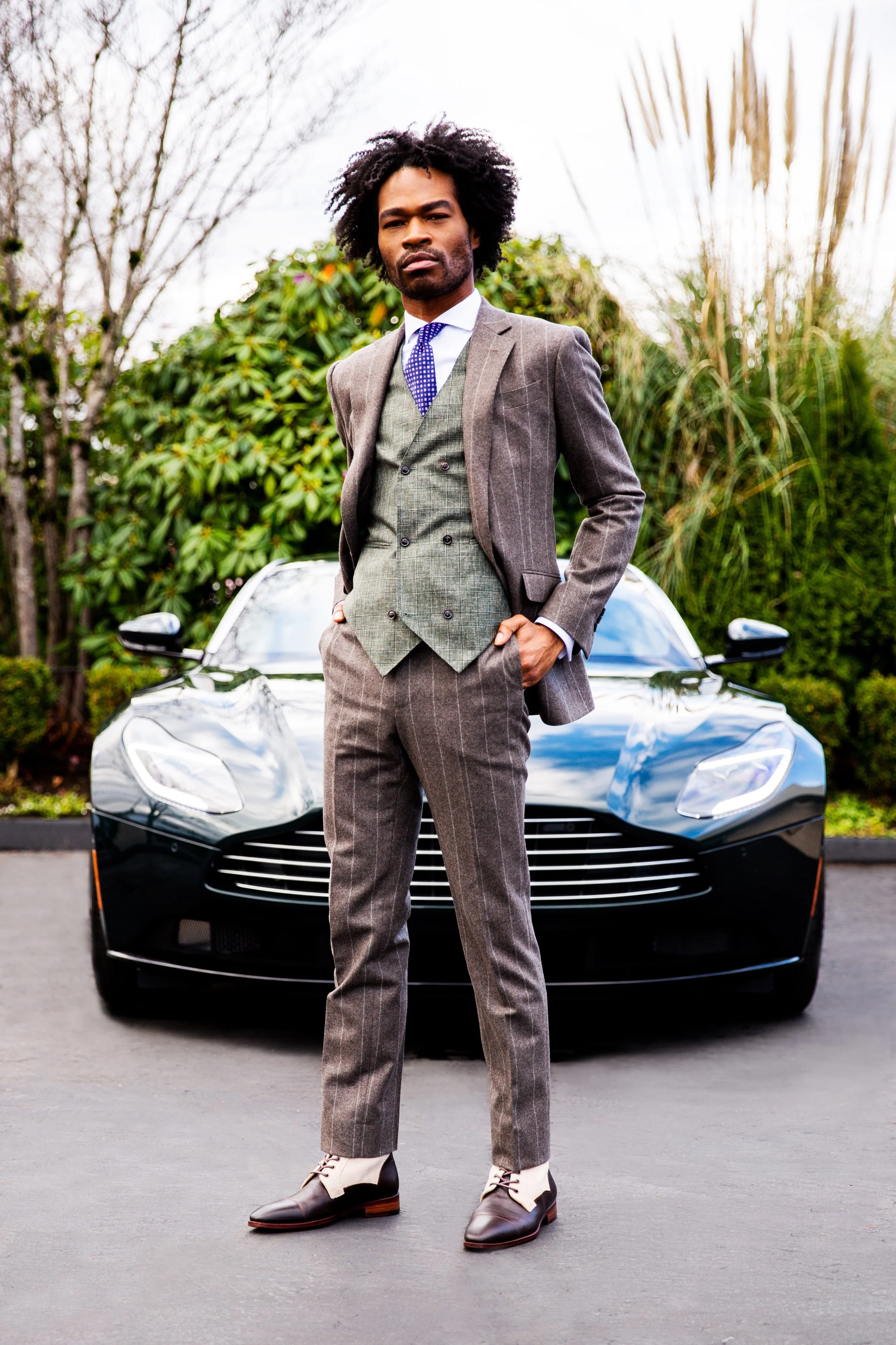 Lifestyle fashion photoshoot for a suit company in Lisbon with an Aston Martin car.