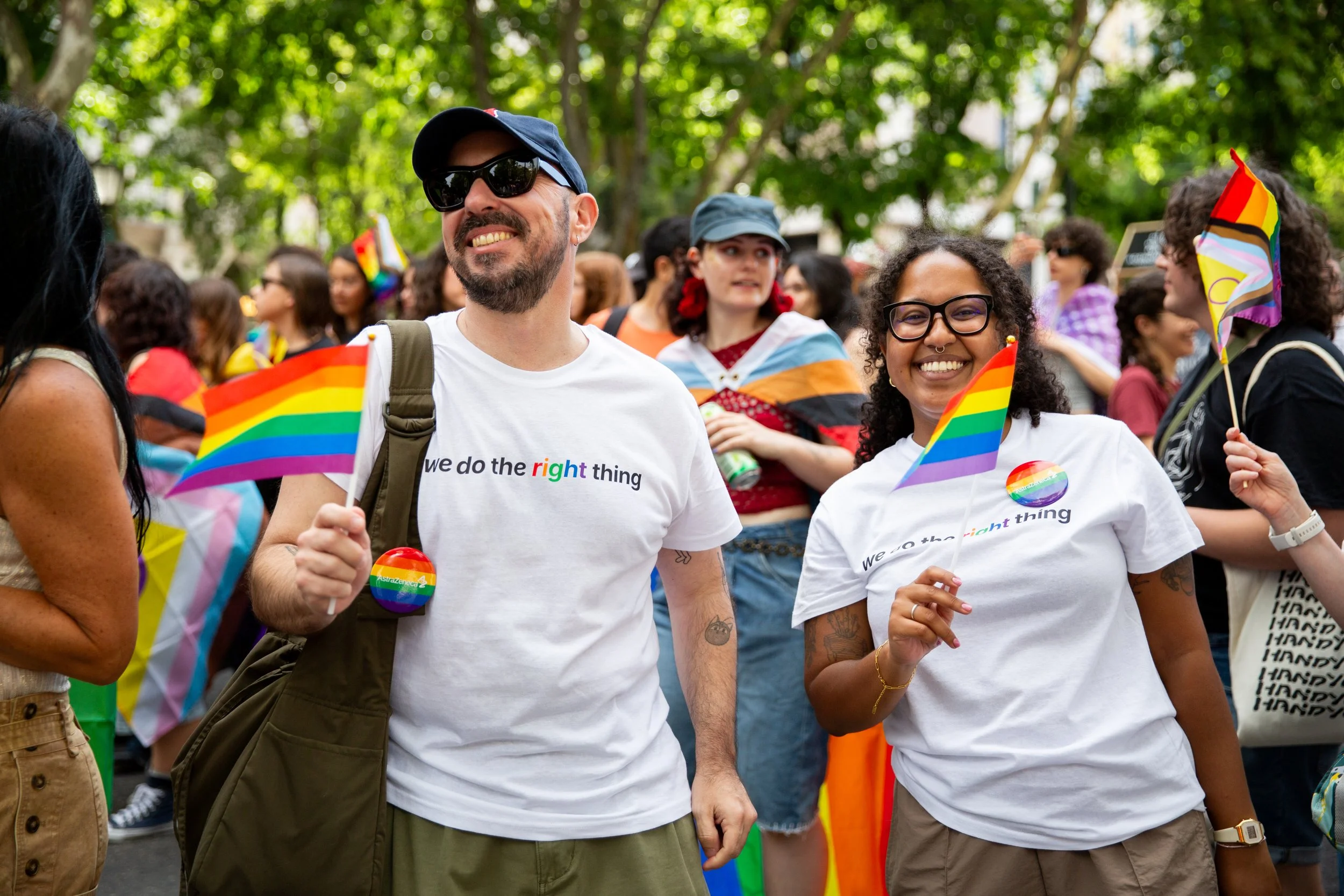 Corporate event photography in Lisbon featuring employees and colleagues walking together during a Pride parade to support LGBTQ+ rights and equality. Professional photography captures the energy, solidarity, and sense of community of this important 