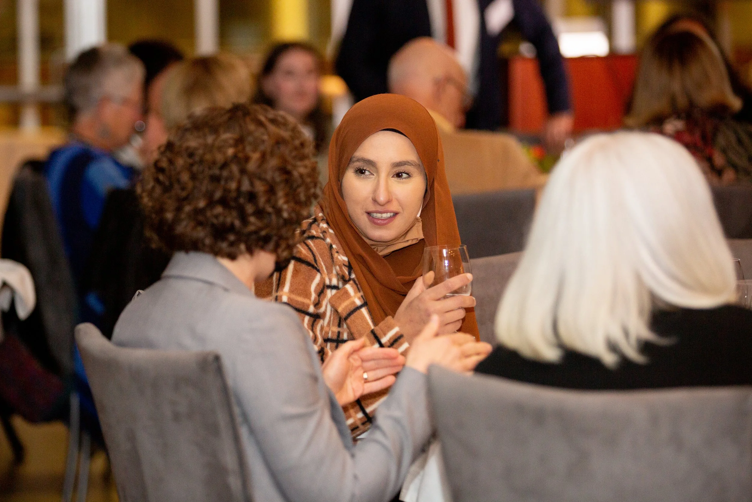 A professional event celebrating women in the legal profession, featuring an award ceremony recognizing the achievements and contributions of women lawyers. Corporate event photography captures the atmosphere, accomplishments, and memorable moments o