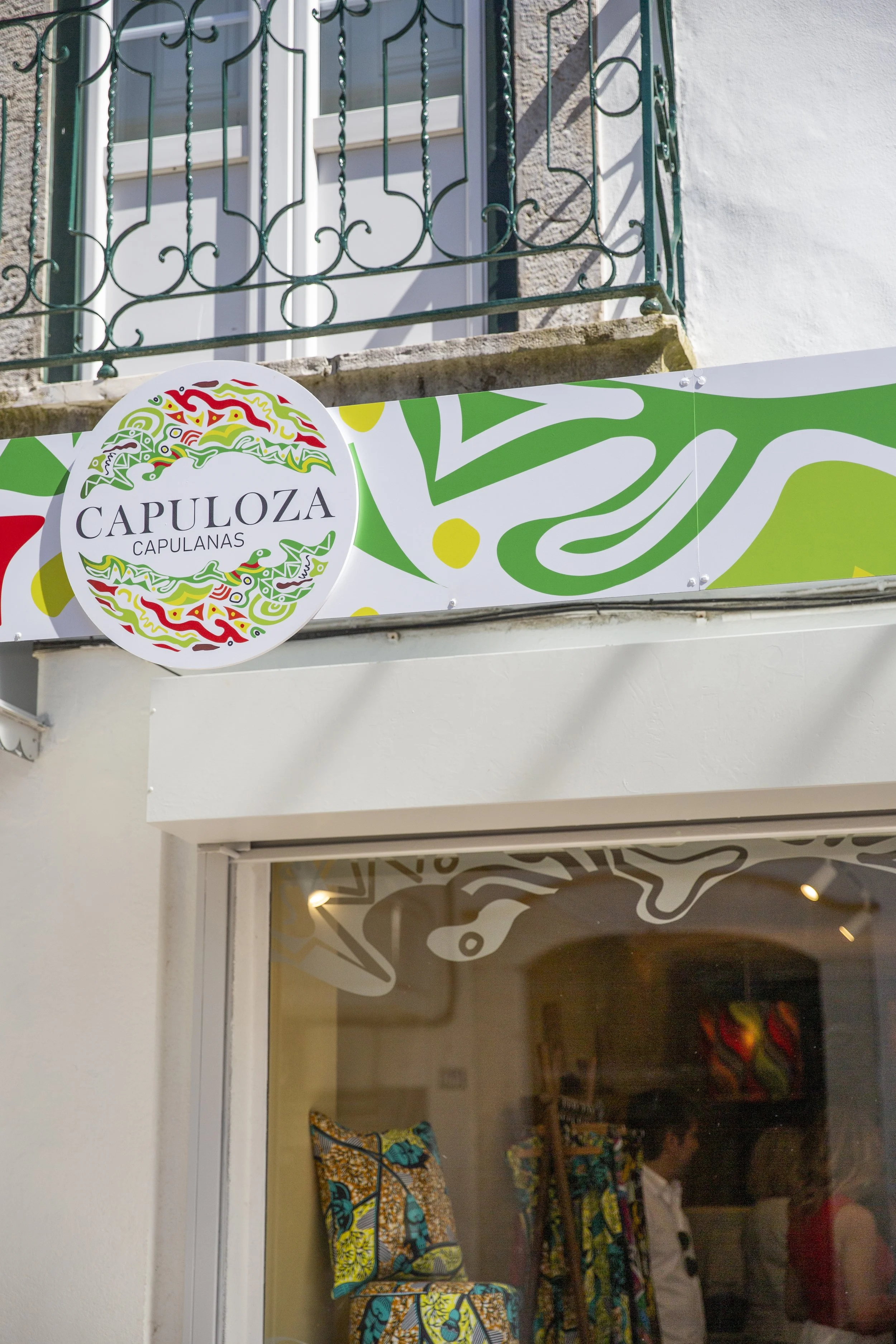Branded photo of a business sign and storefront in Lisbon.