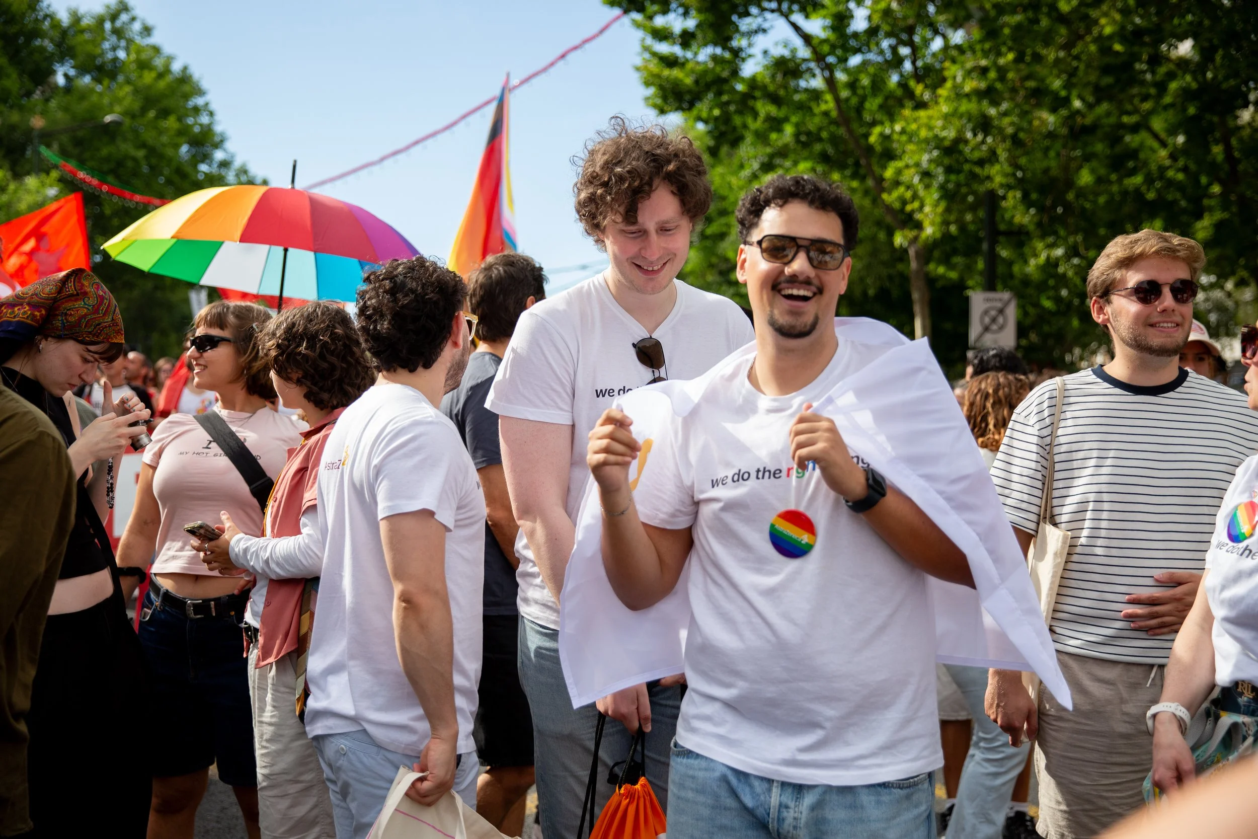 A corporate group participating in a Pride parade in Lisbon, Portugal, walking together in support of LGBTQ+ rights, equality, and inclusion. This event photograph captures a meaningful moment of visibility, community, and corporate allyship.