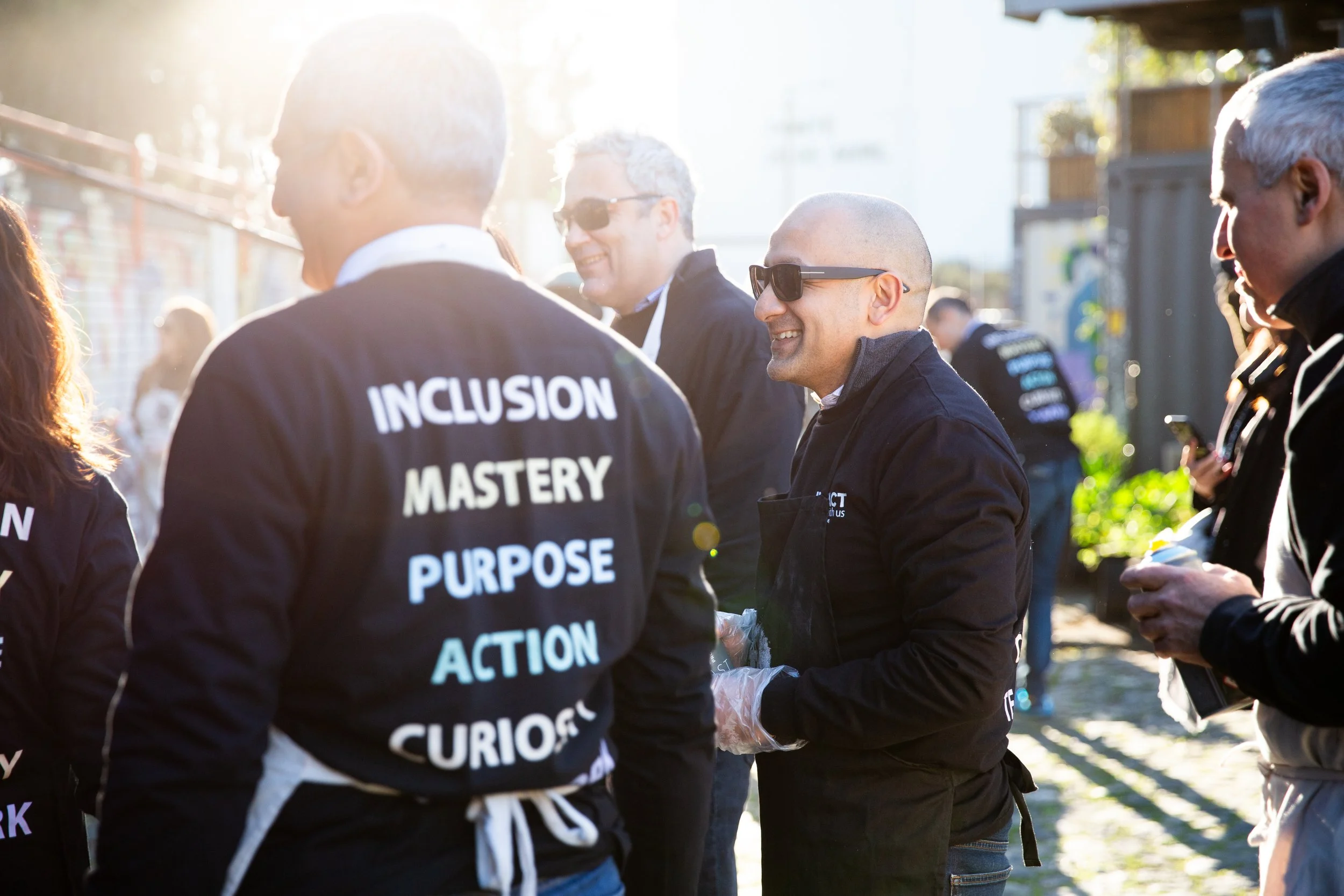 Professional corporate event photography in Lisbon, Portugal, capturing employees participating in a creative graffiti workshop as part of a team-building event. This image highlights collaboration, creativity, and team connection during a unique cor