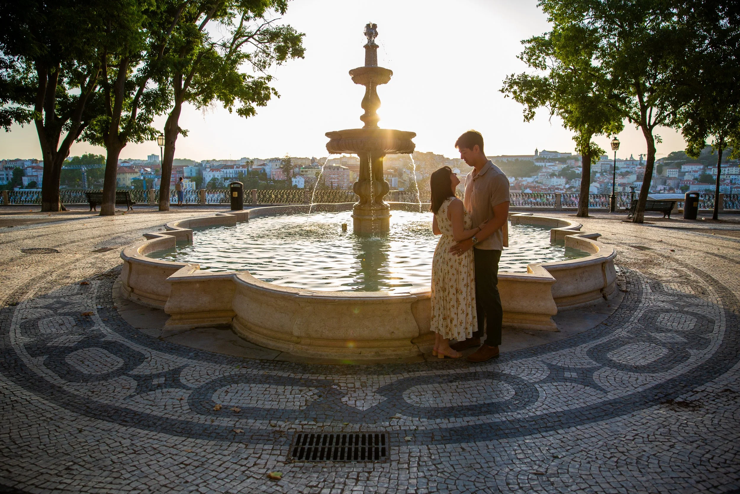 Sunrise couples photography session in Lisbon, Portugal, capturing a couple enjoying their vacation at Miradouro Sao Pedro de Alcantara.