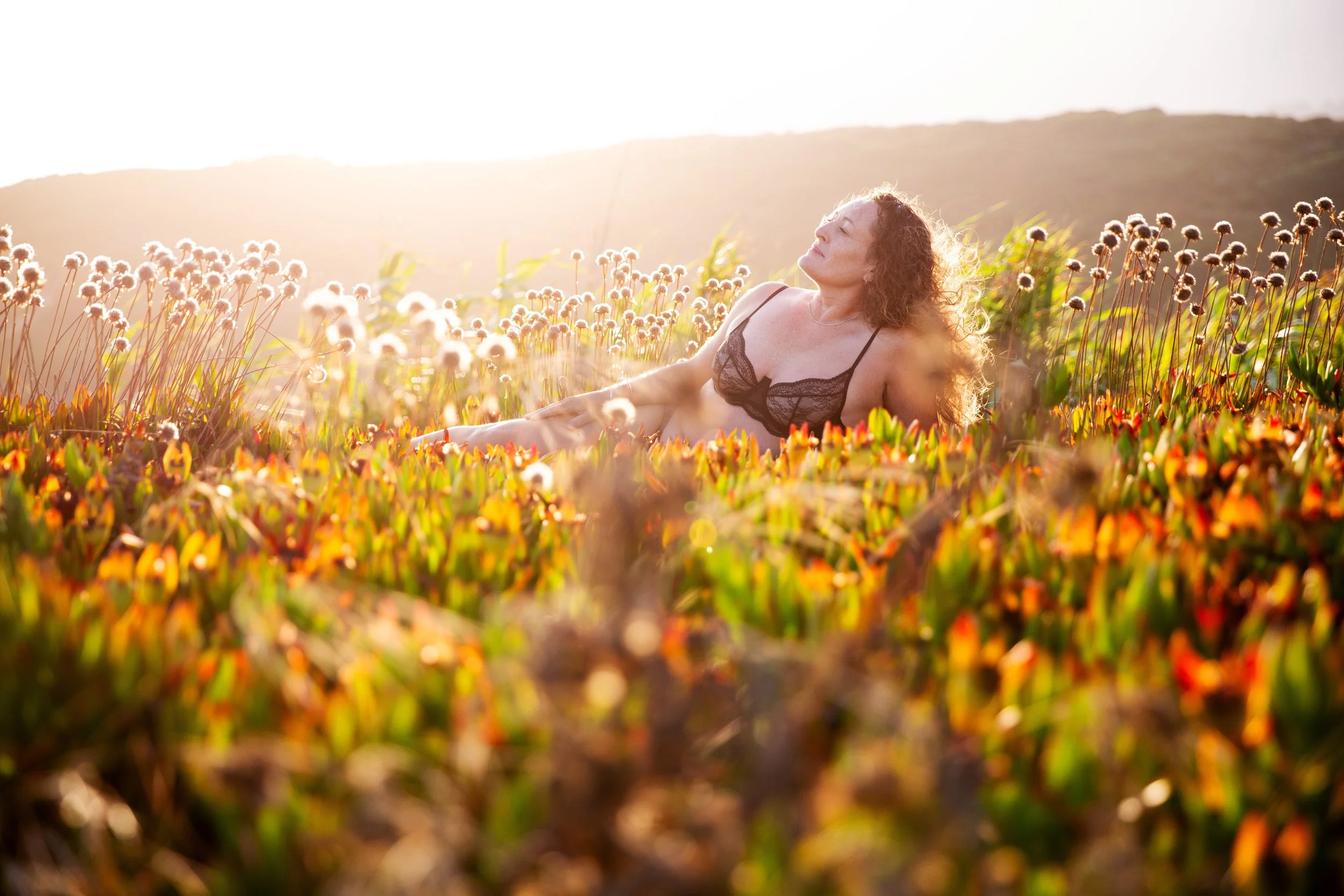 Empowering nature boudoir photoshoot at sunrise in Lisbon at Cabo da Roca during a golden hour photo session.