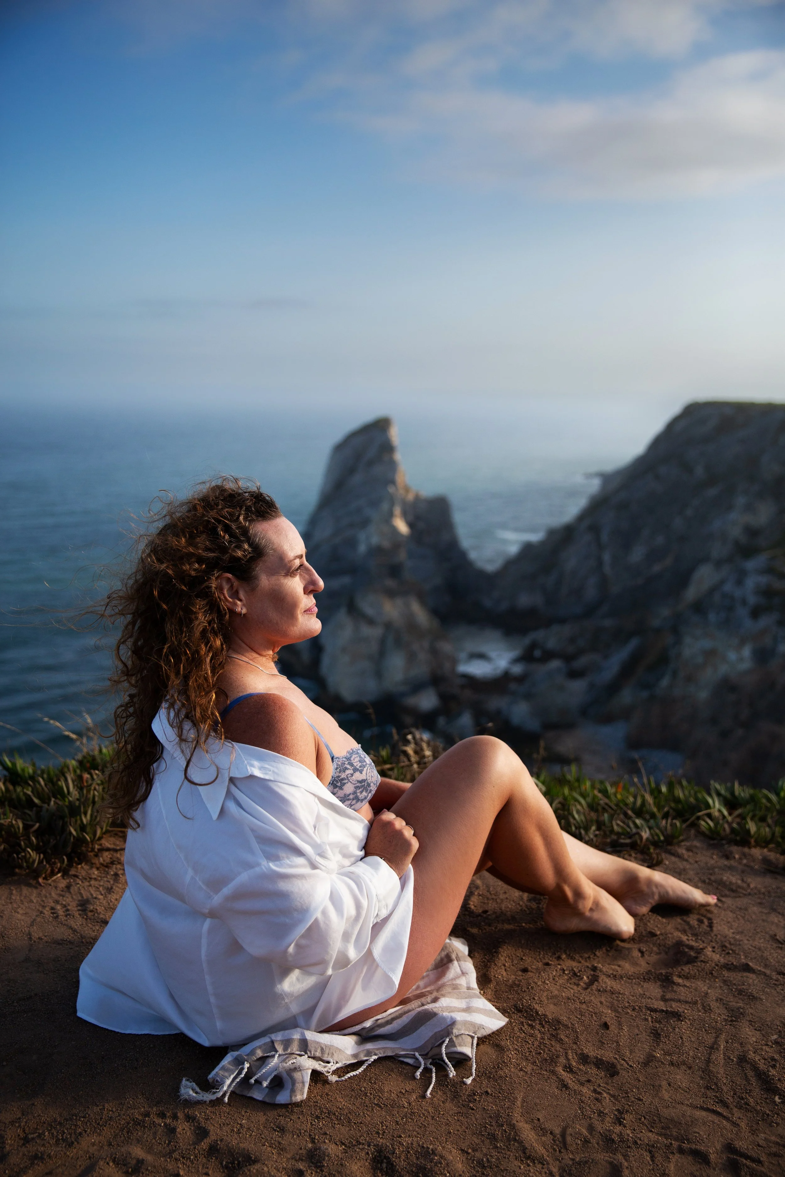Empowering nature boudoir photoshoot at sunrise in Lisbon at Cabo da Roca during a golden hour photo session.