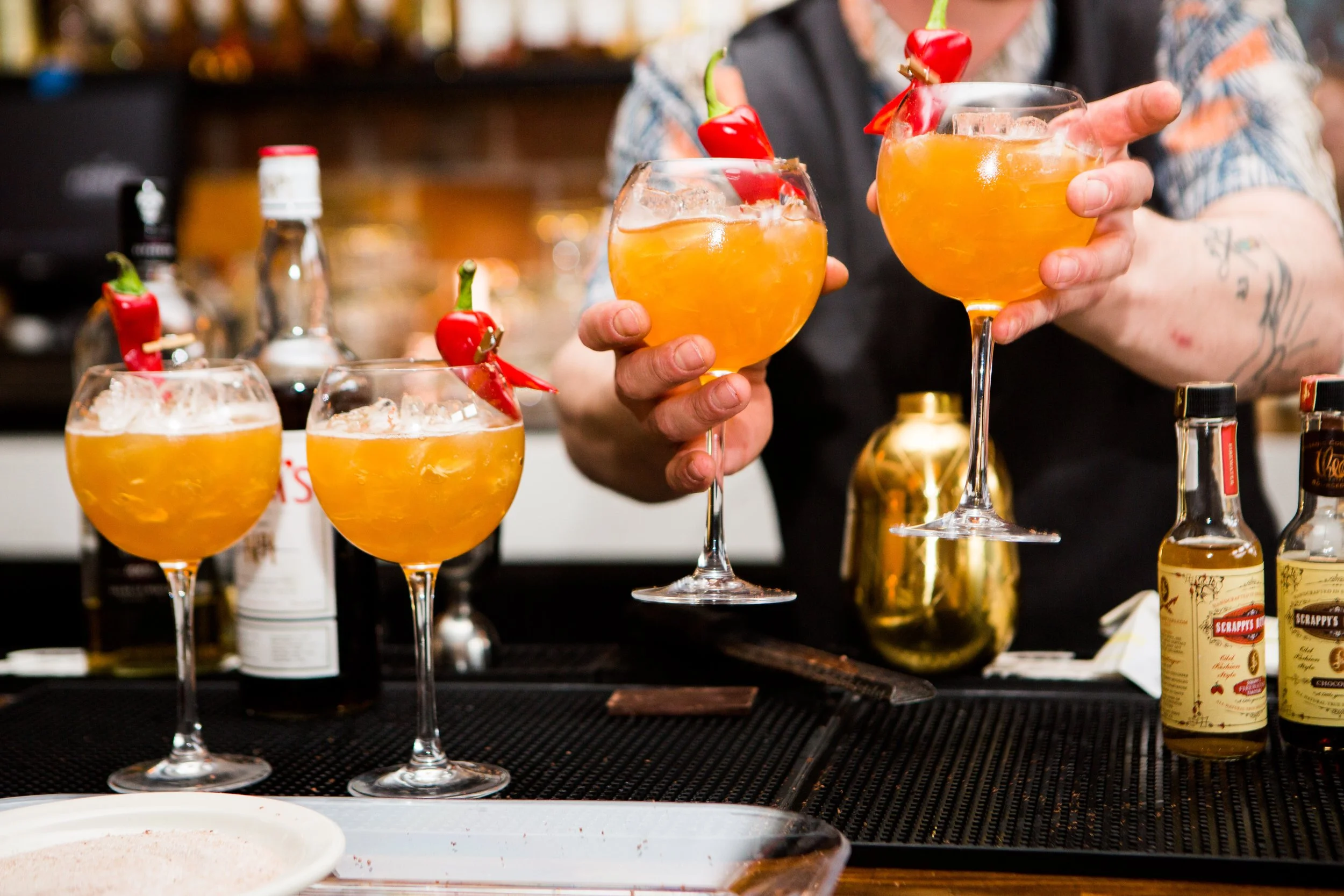 Professional cocktail event photography in Lisbon, Portugal, capturing the branded content and a candid moment during the event.