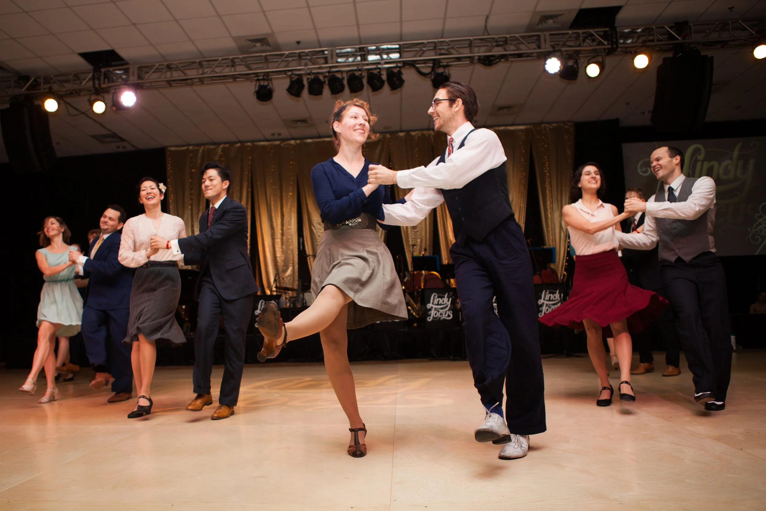 Dancers performing at a large dance event in Lisbon, Portugal, captured by a professional event photographer. The energetic atmosphere, expressive movement, and vibrant social setting showcase the excitement of Lisbon’s dance and cultural events.