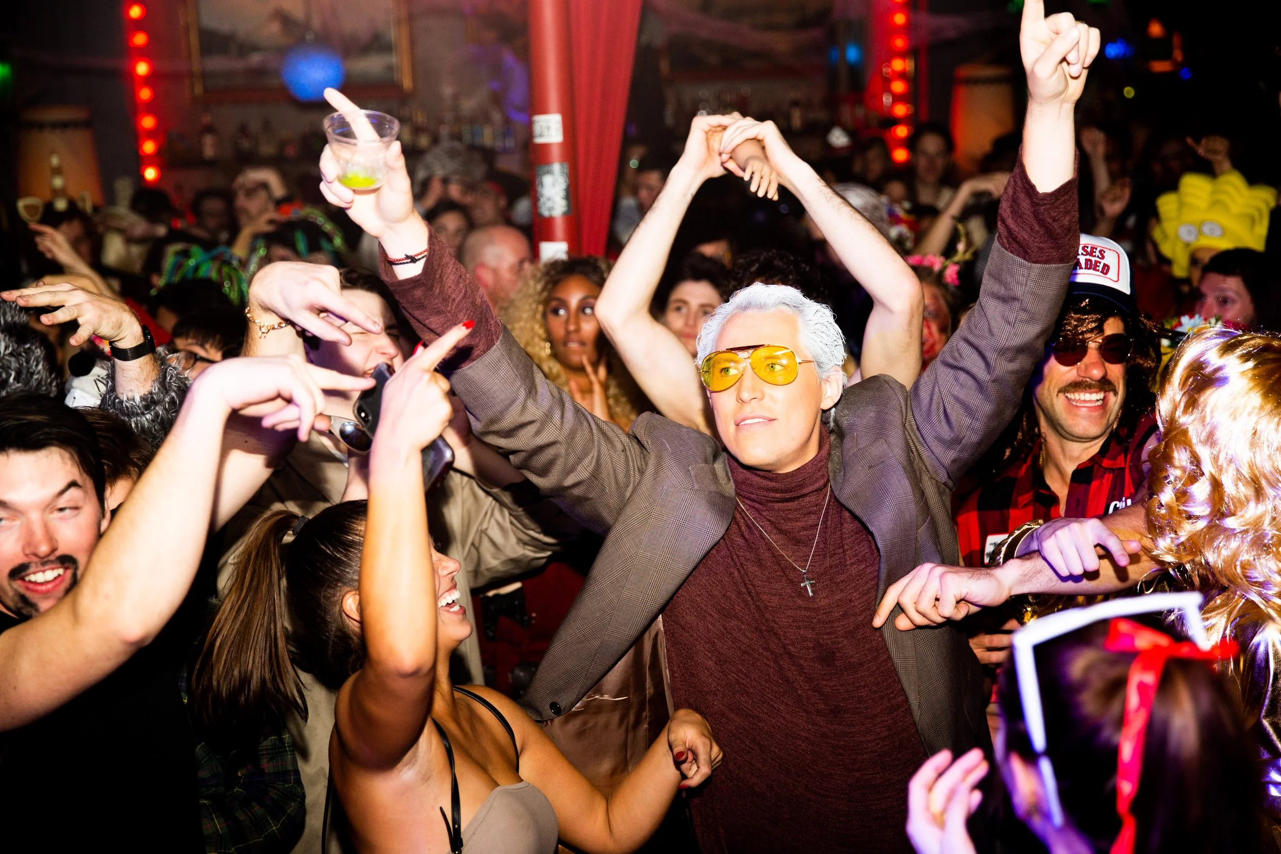 A group of guests enjoying a corporate Halloween party in Lisbon, Portugal, surrounded by festive decorations and a fun, celebratory atmosphere. Professional event photography captures the costumes, connections, and memorable moments of company Hallo